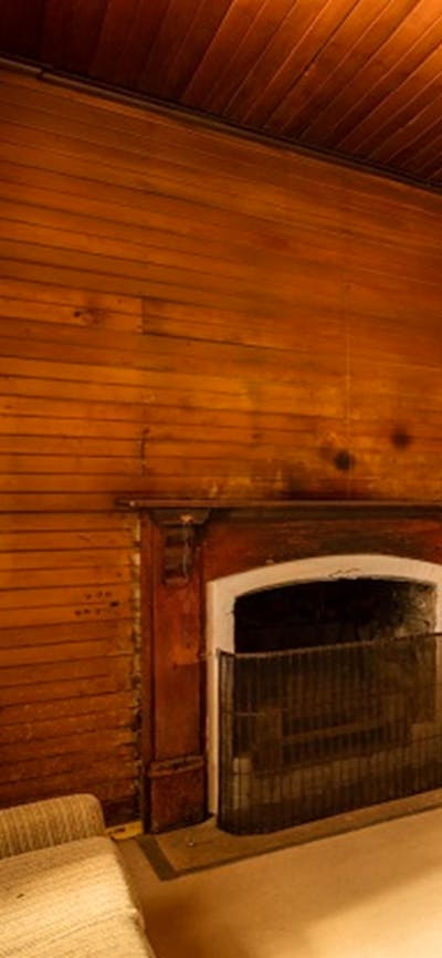 Daffodil Cottage fireplace and living room, Kosciuszko National Park. Photo: Murray Vanderveer/OEH