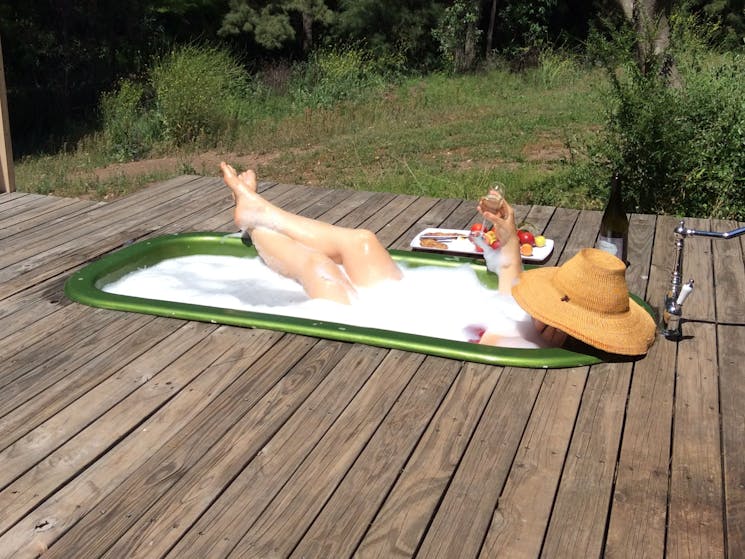 Guests enjoying a hot bath while drinking Champagne , listening to the bird life and creek!!