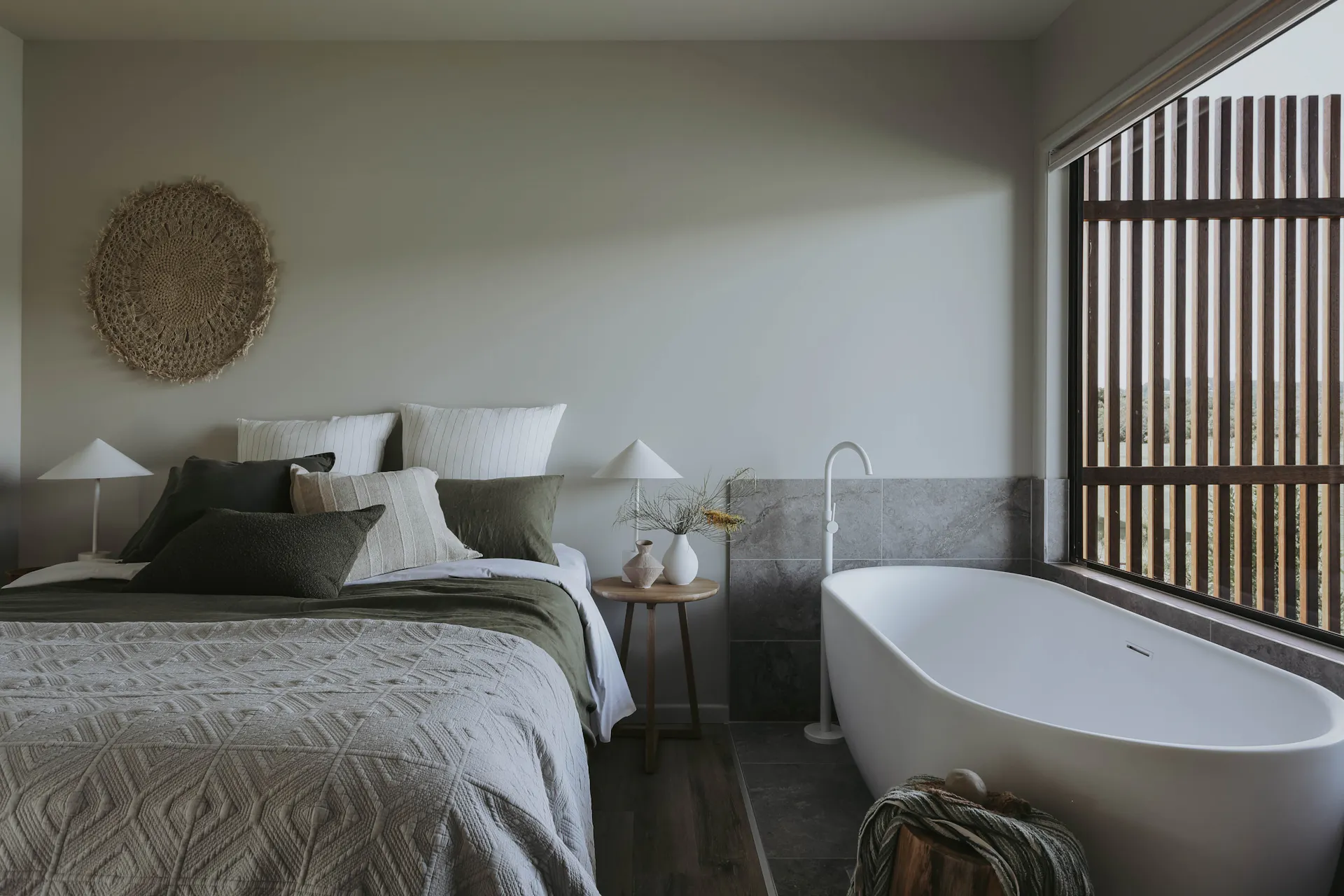 View looking at queen bed and freestanding bath in master bedroom