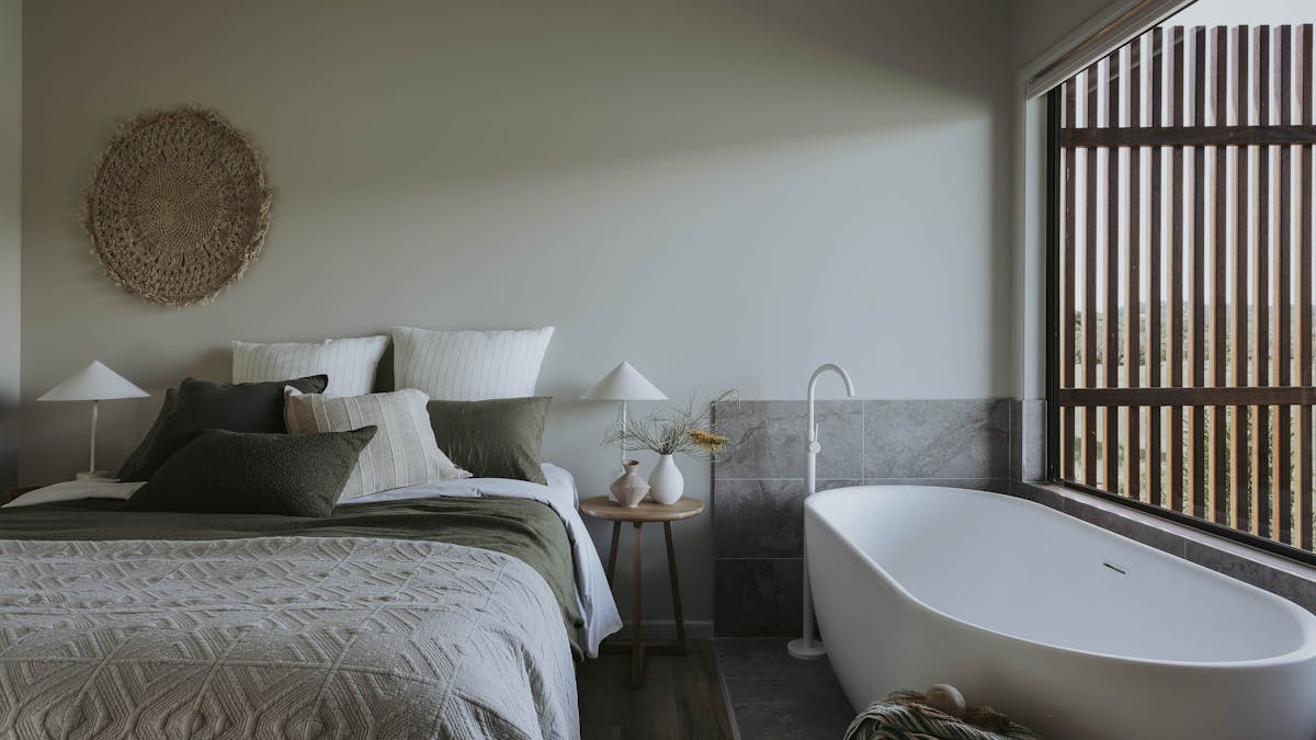 View looking at queen bed and freestanding bath in master bedroom