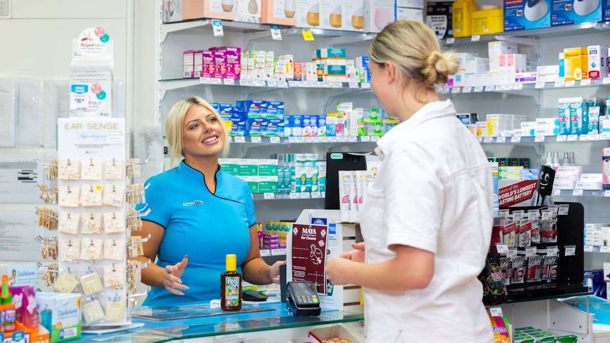 Two women interacting at the checkouts within a pharmacy at Circle on Cavill
