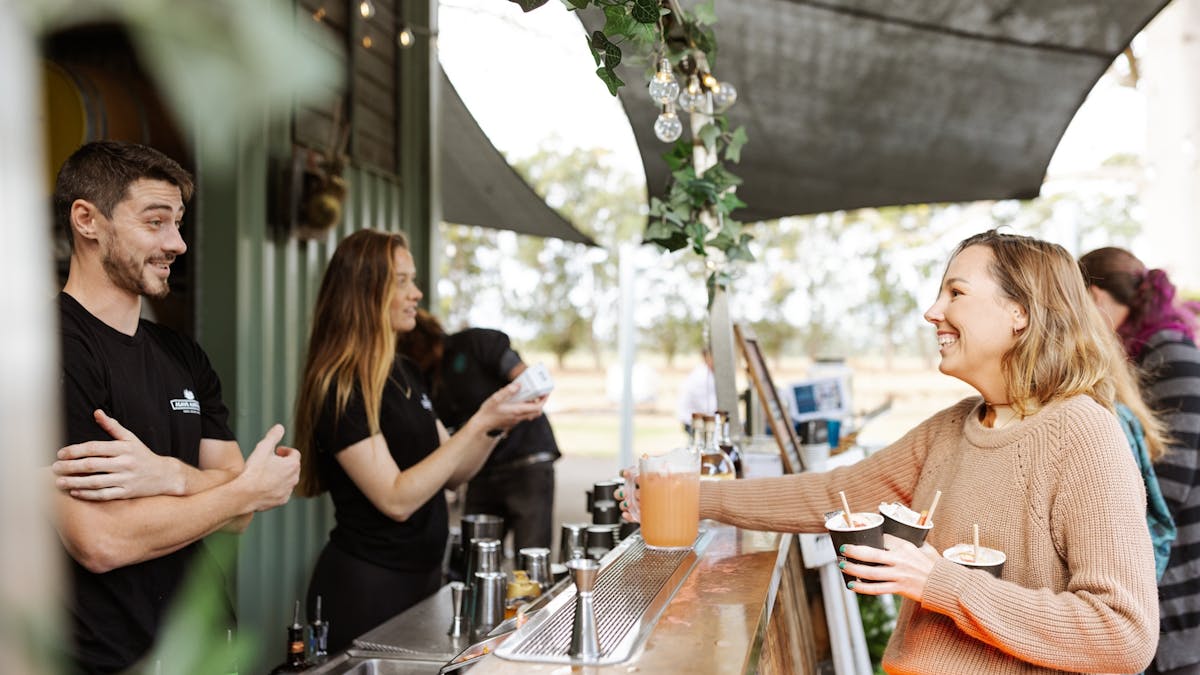 Visitor being served drinks at Mt Uncle Distillery bar
