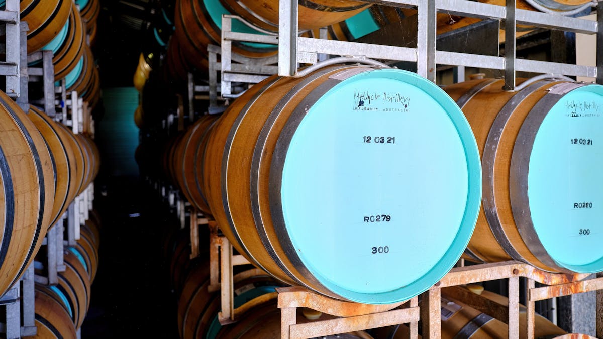 Oak barrels stacked for ageing spirits at Mt Uncle Distillery