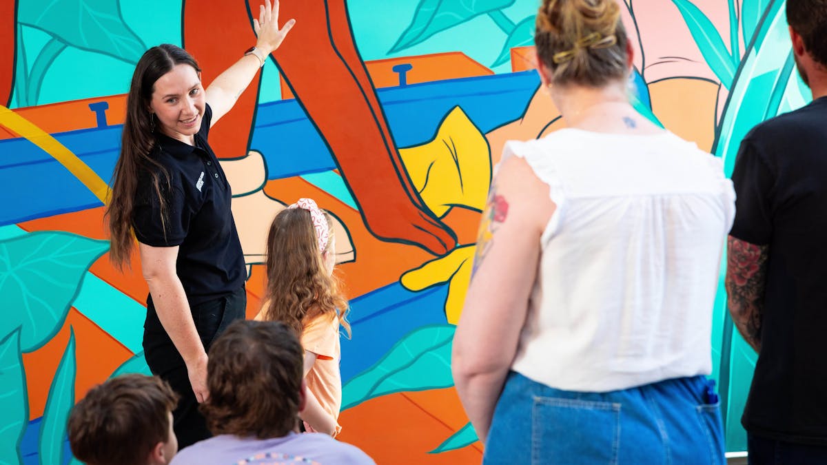 Museum staff member taking a group on a daily museum tour