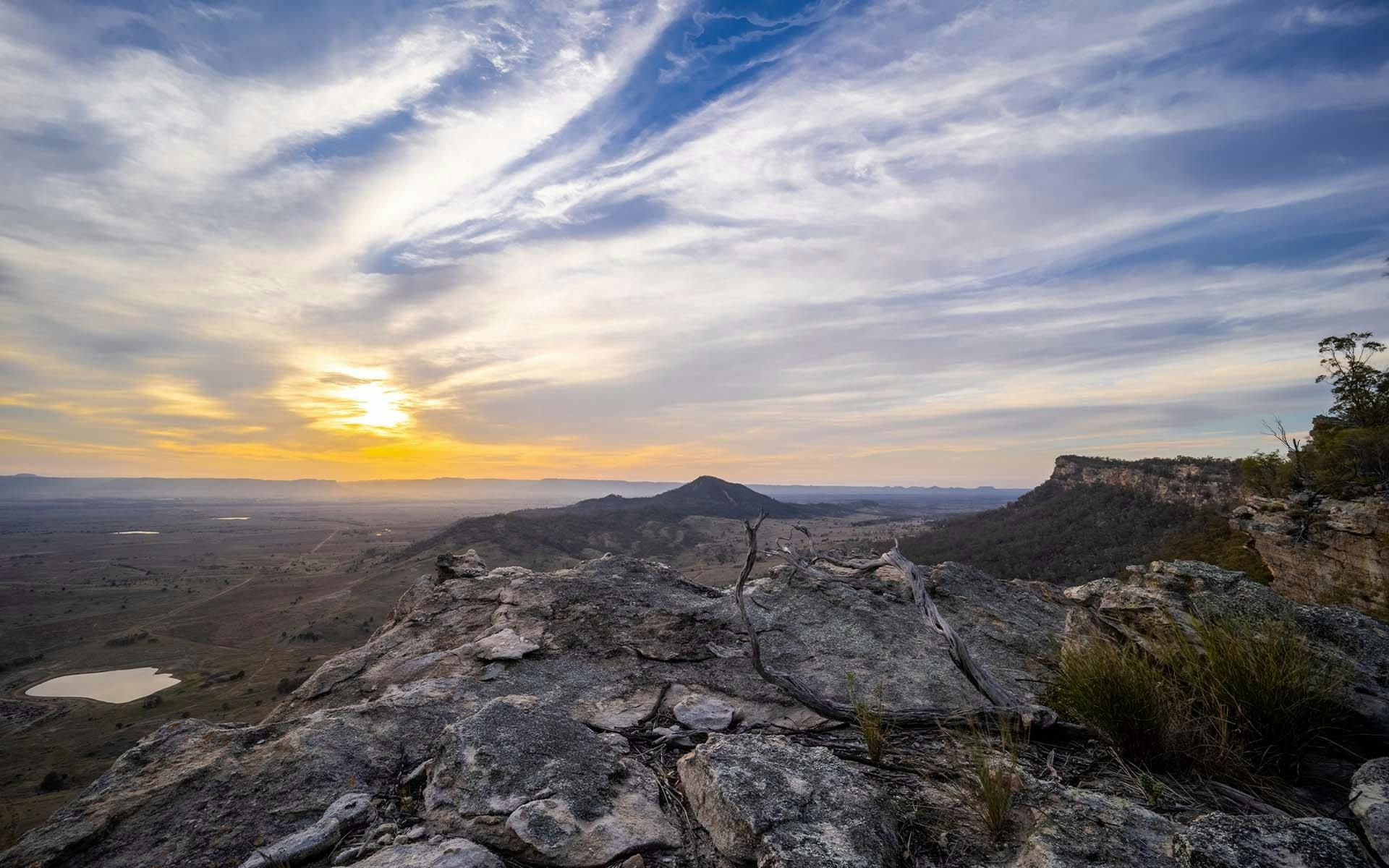 A cliff edge overlooking Arcadia Valley at dusk
