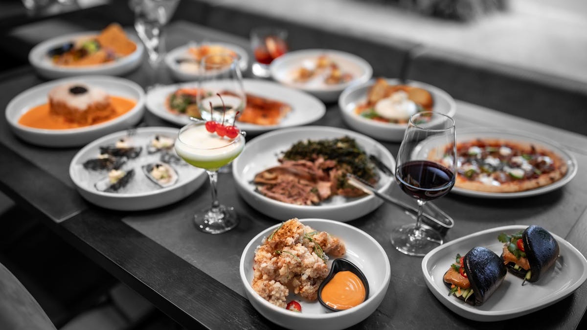 spread of food dishes and cocktails
