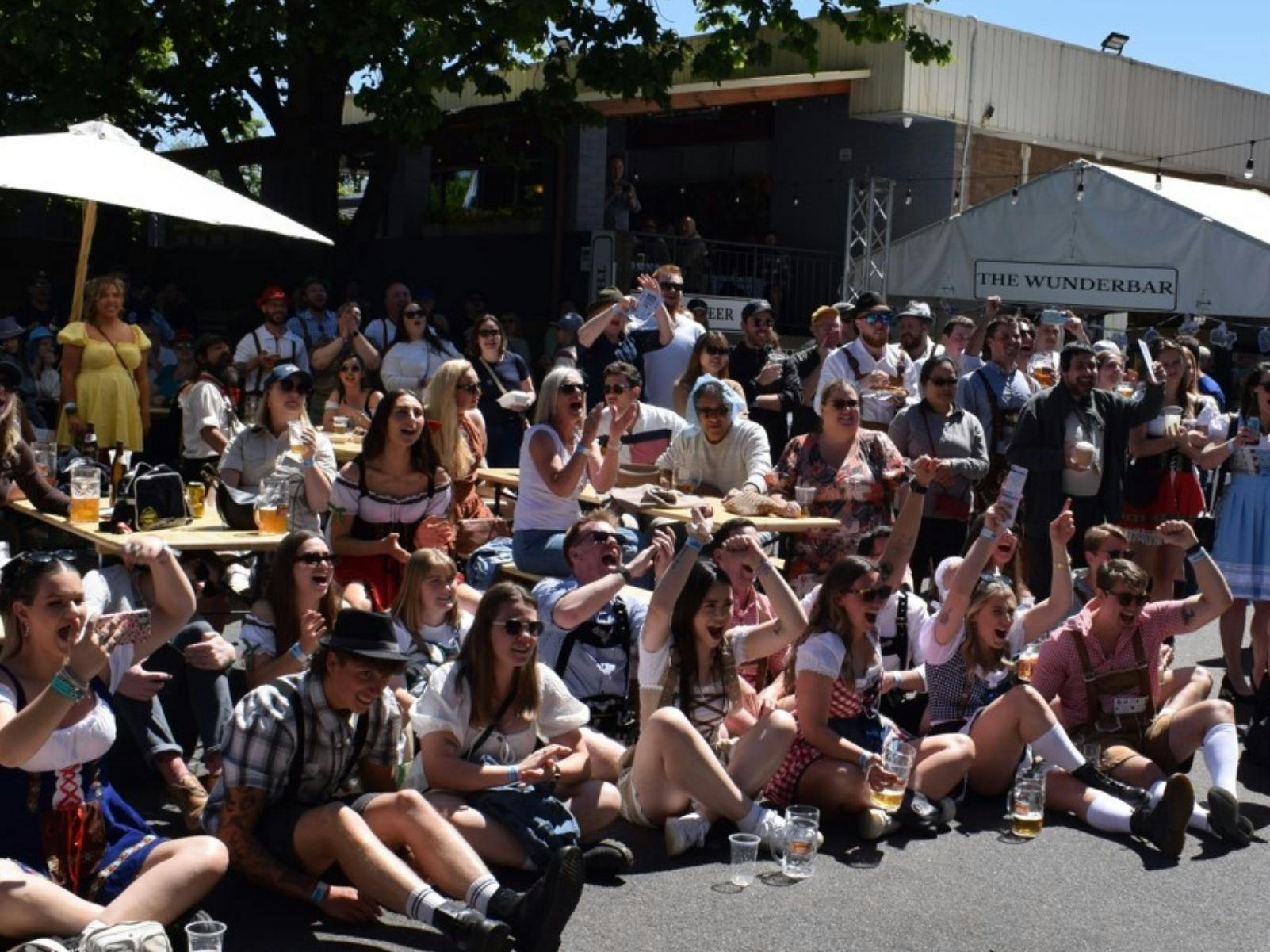Photo of large crowd of people cheering for a competition at Oktoberfest 2025