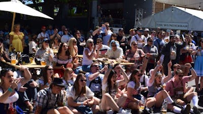 Photo of large crowd of people cheering for a competition at Oktoberfest 2025