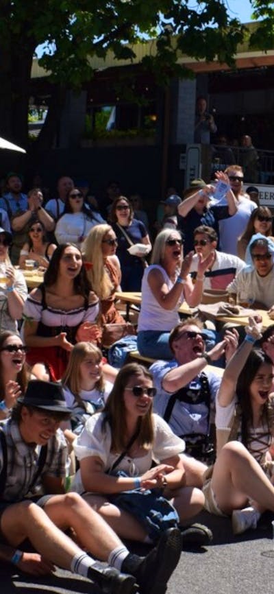 Photo of large crowd of people cheering for a competition at Oktoberfest 2025