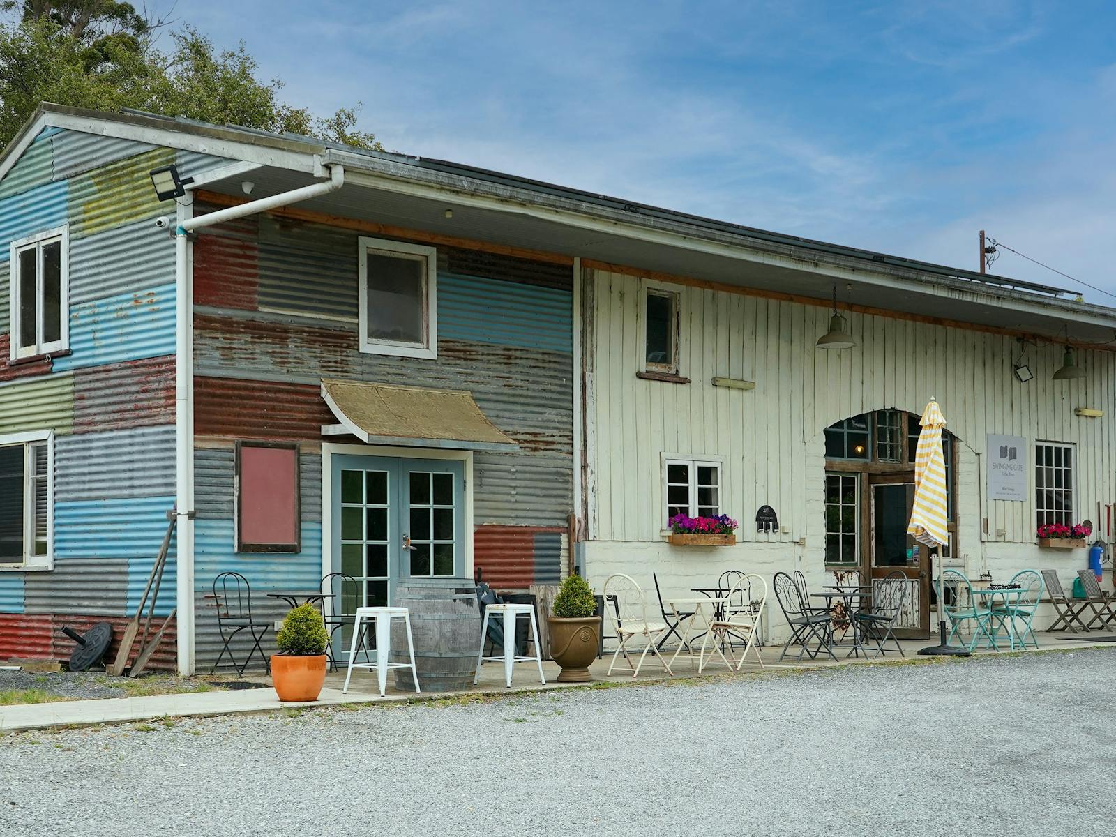 picture of rustic cellar door covered with corrugated iron panels with different colours