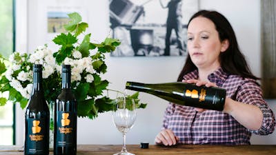 Stephanie pouring wine for tasting in the cellar door