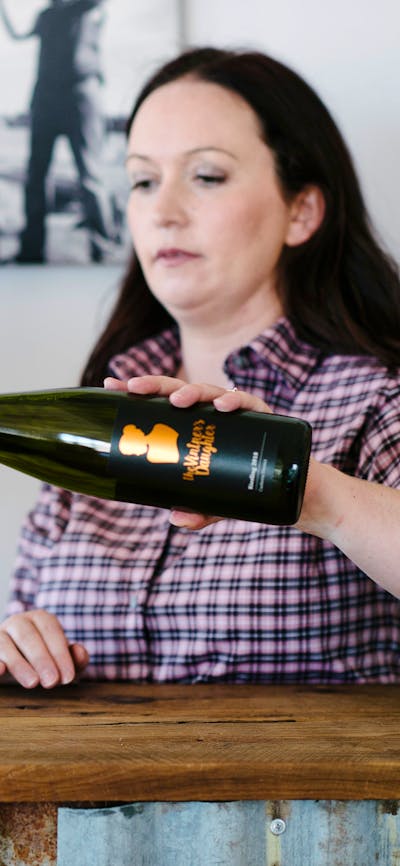 Stephanie pouring wine for tasting in the cellar door