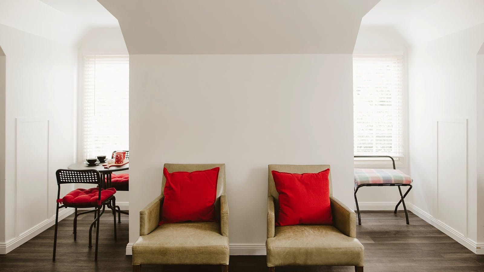 The Loft living area - dining nook, comfy leather chairs and luggage rack with ironing facilities