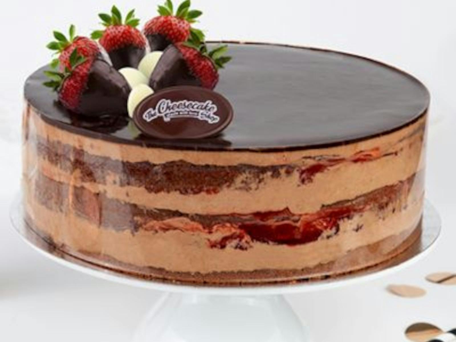 A chocolate cheesecake with strawberries on top