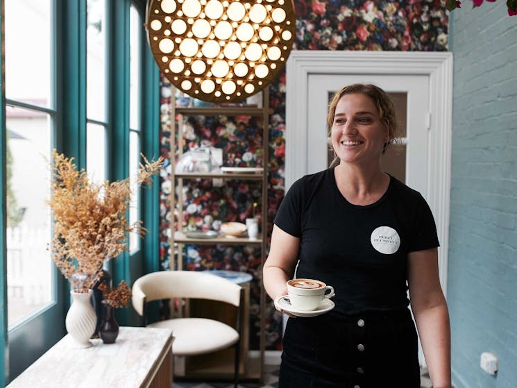 Waitress holding a coffee