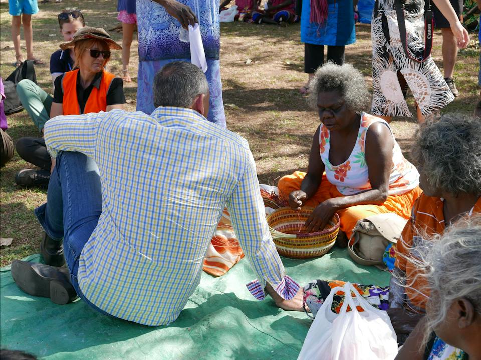 Christine Nabobbob gives visitors a demonstration of Kunwinjku weaving styles