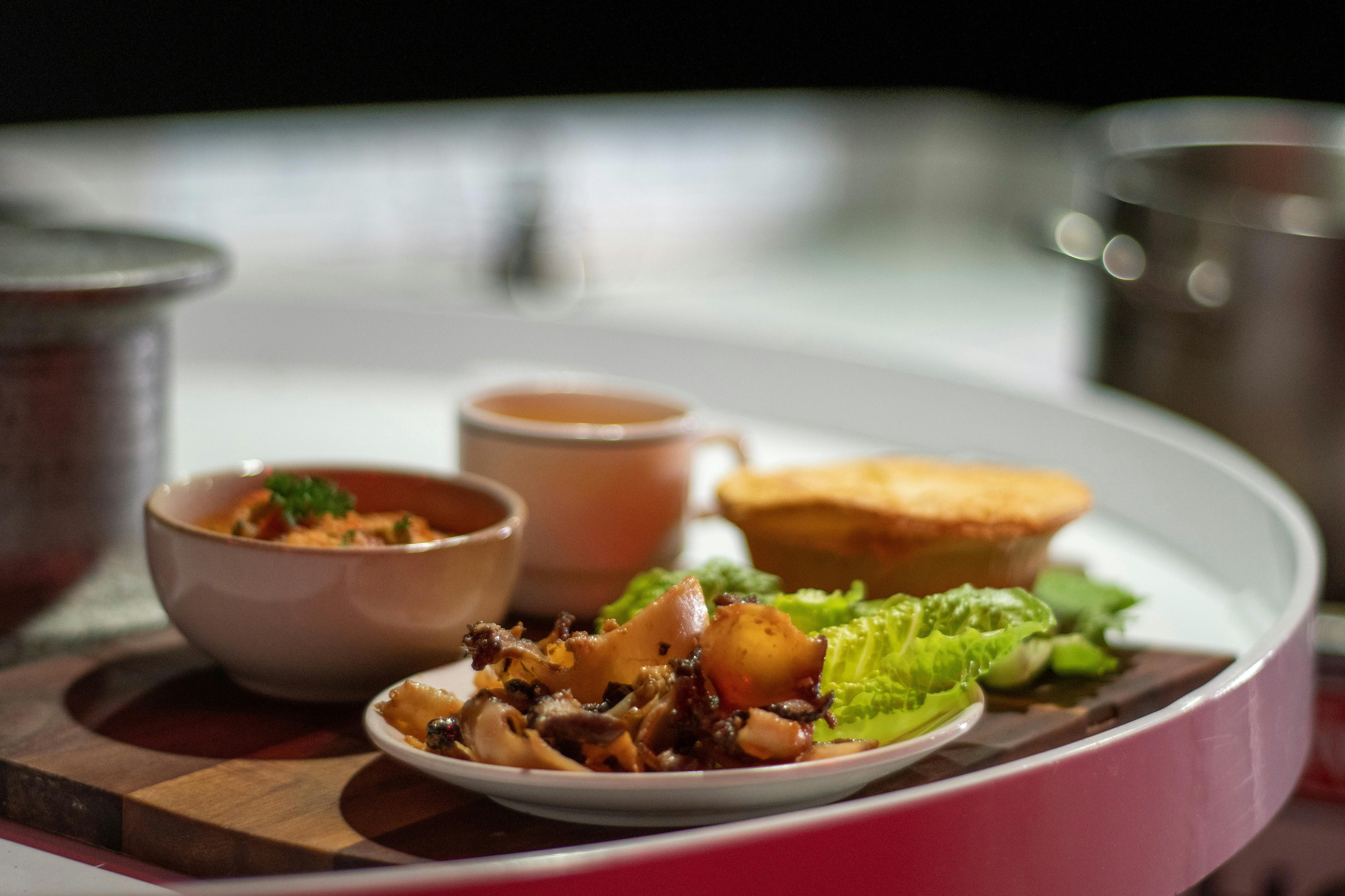 Photo of plated abalone, soup, pie and white cup
