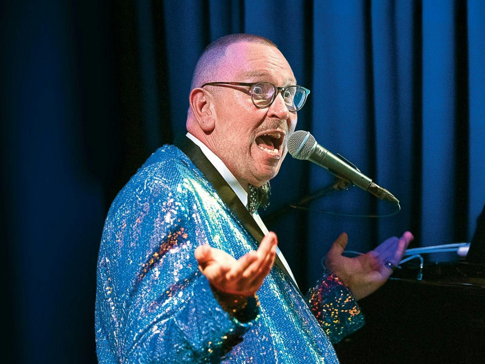 a man wearing shiny blue blazer