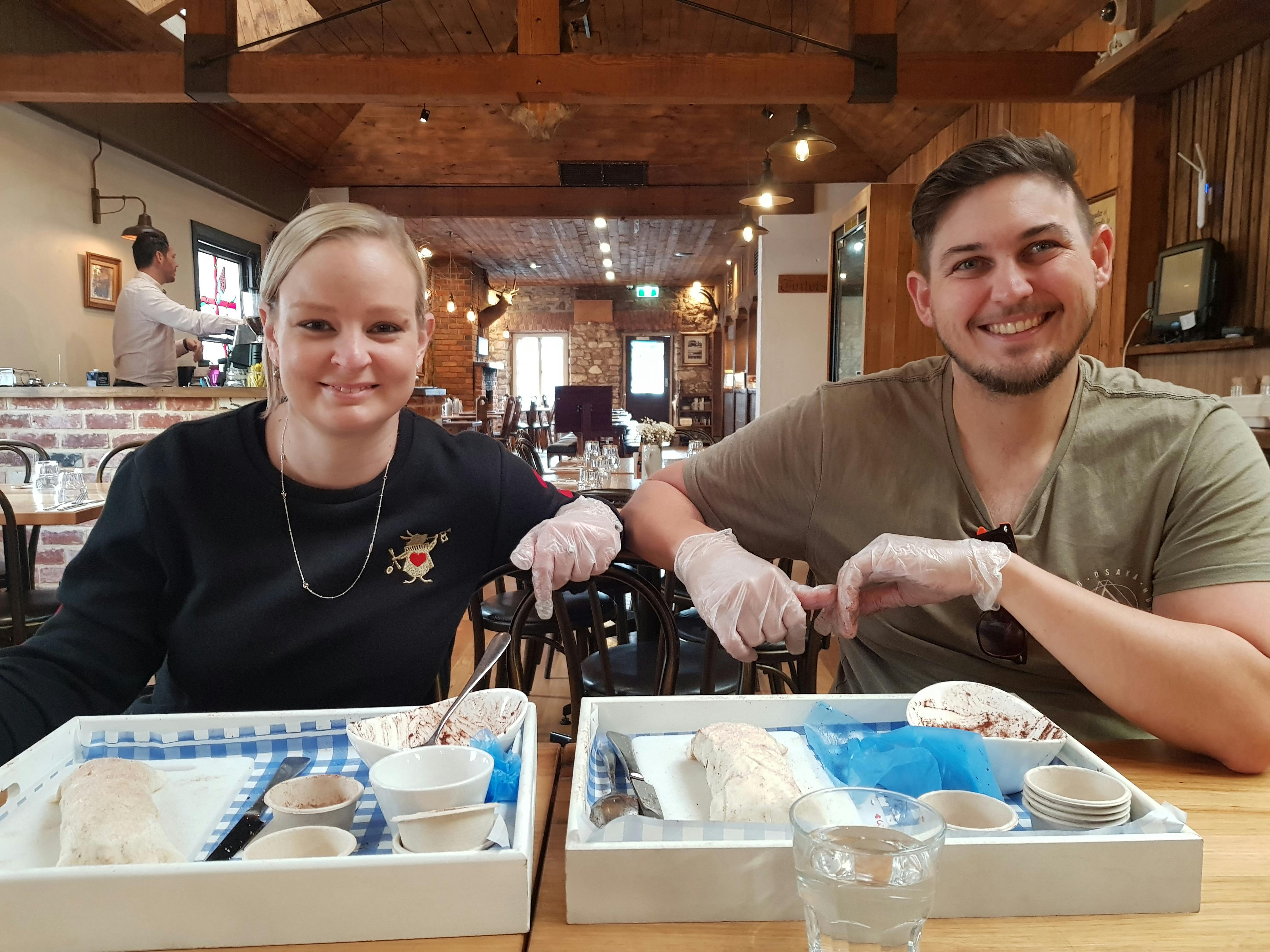 Man and Woman showing their constructed apple strudel