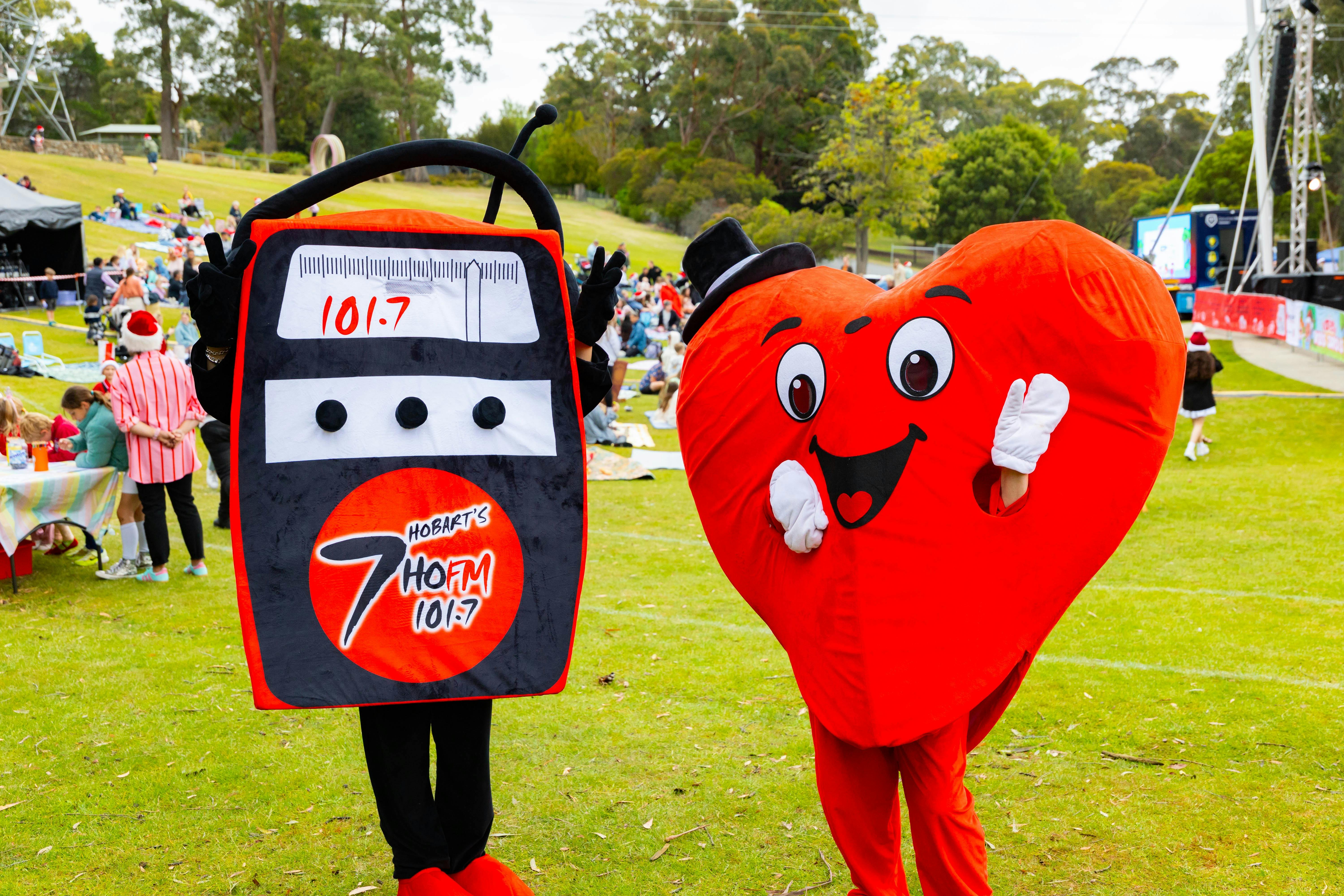 Variety Mascot Hearty (red heart) with 7HOFM mascot radio Banger