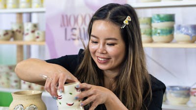 Mooody Lemon holding a ceramic cup
