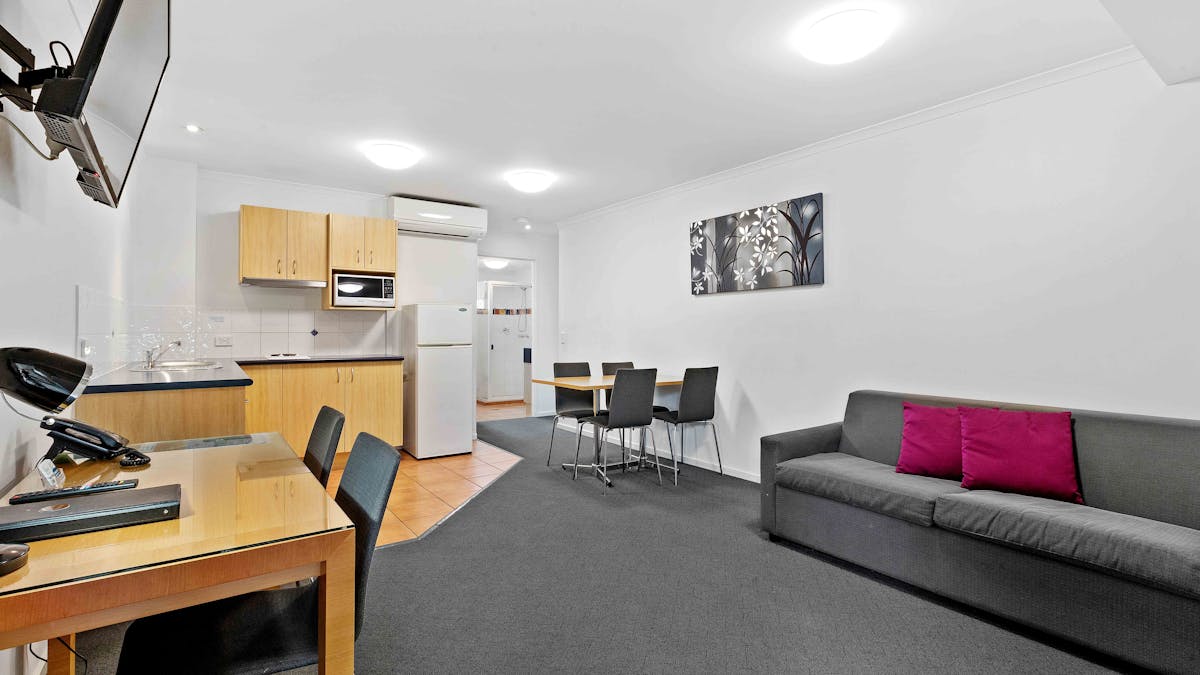 Loungeroom of our Family Suite; including sofa bed, kitchen and dining
