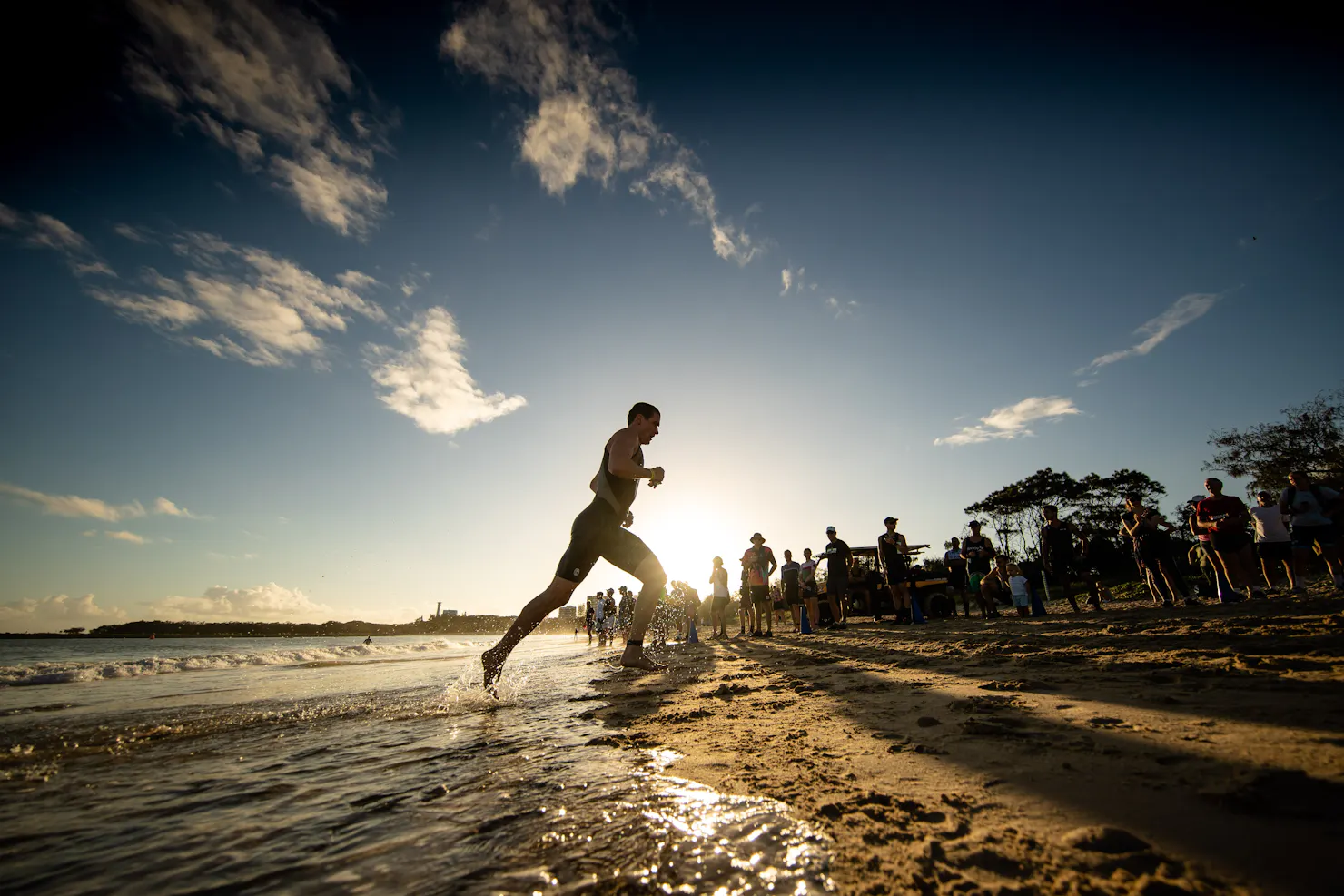 Swimmer runs in from the ocean onto beach