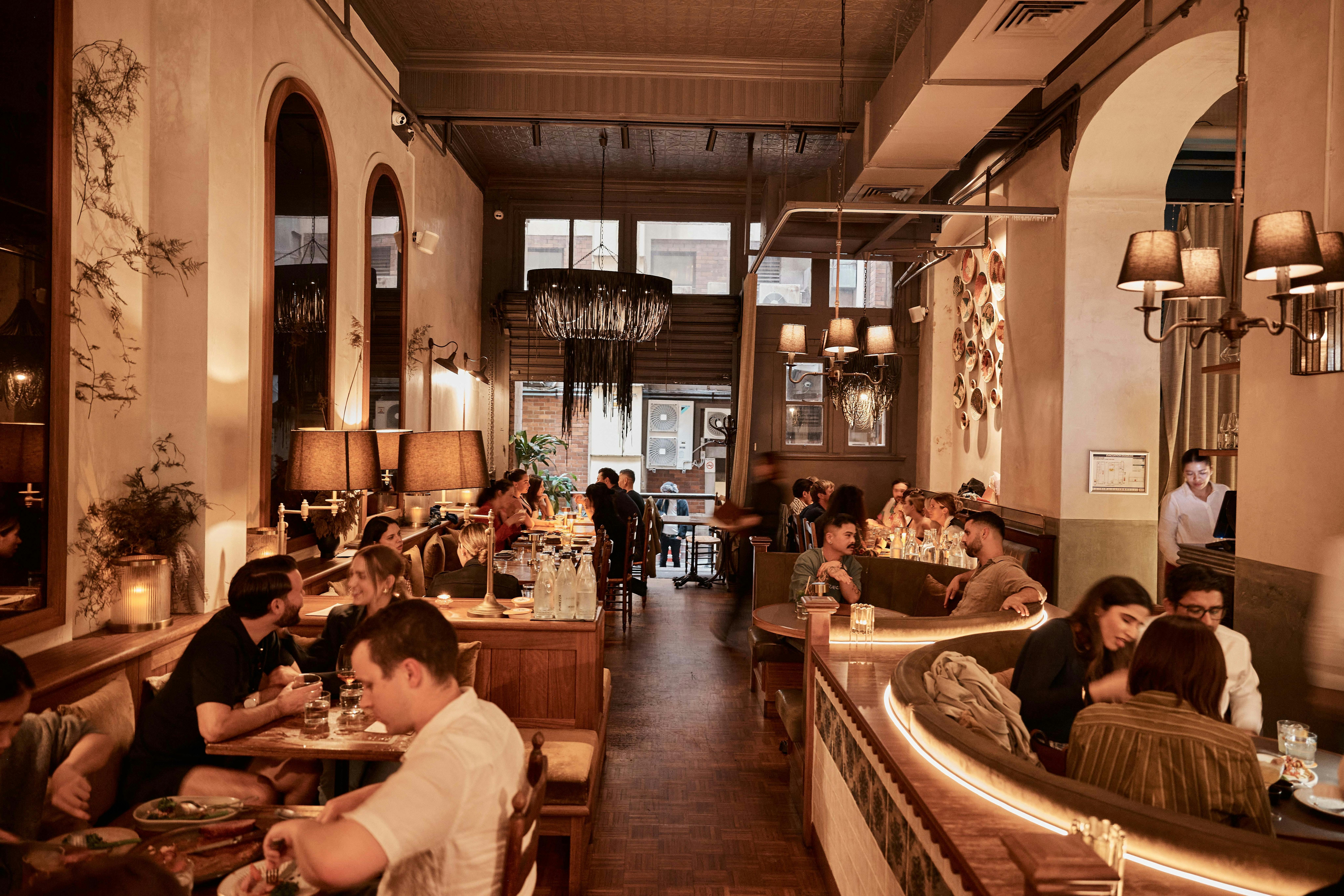 the dinig area of a busy restaurant, with a mix of booth and table seating