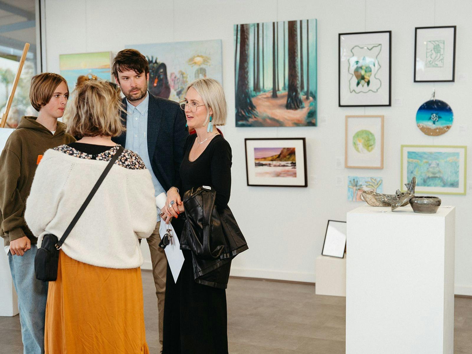 Connecting over art and conversation in a welcoming gallery space.
