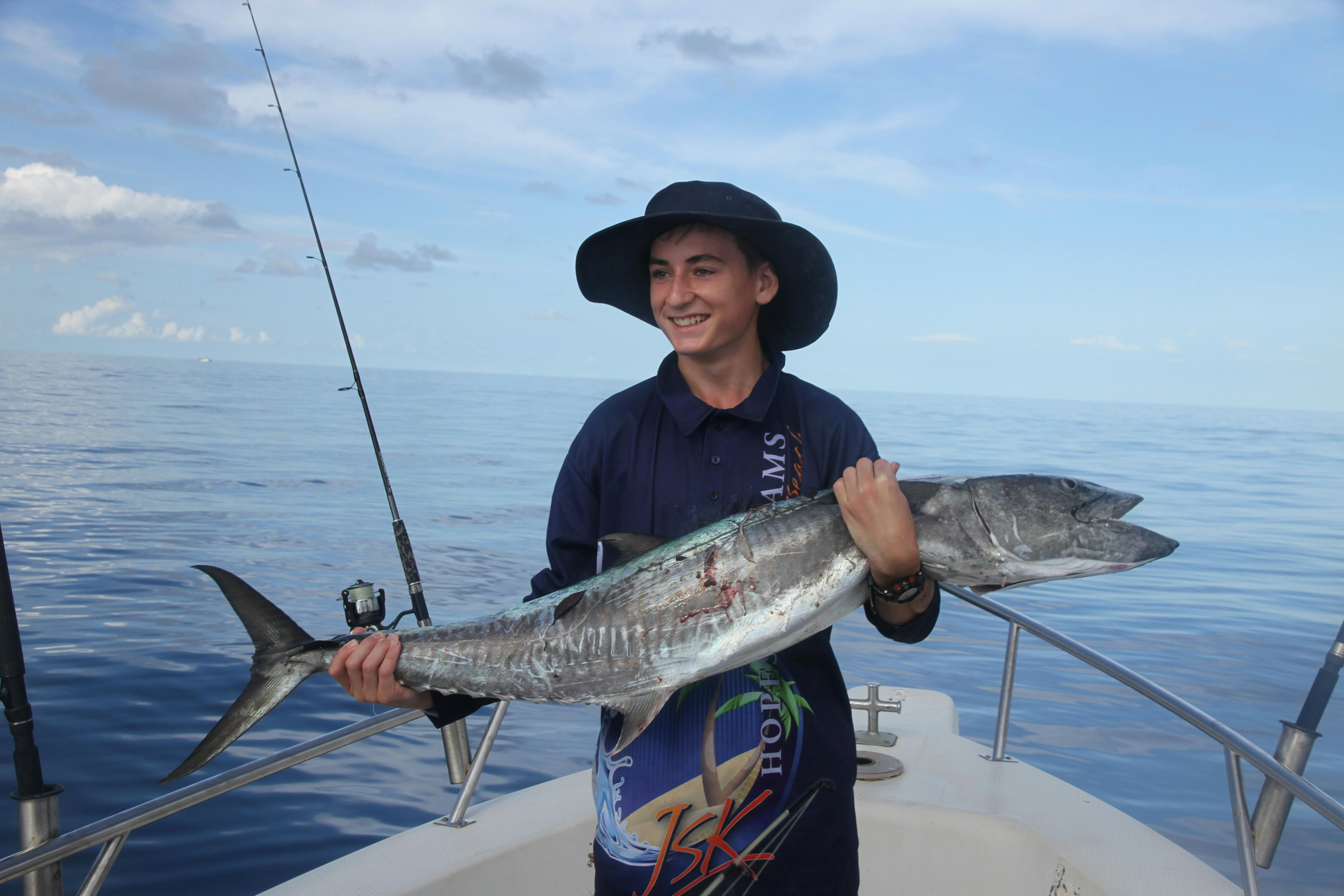 Young boy holding a fish