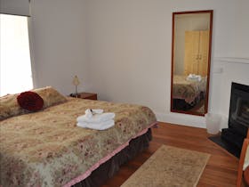 The first bed room features a queen size bed and fireplace.
