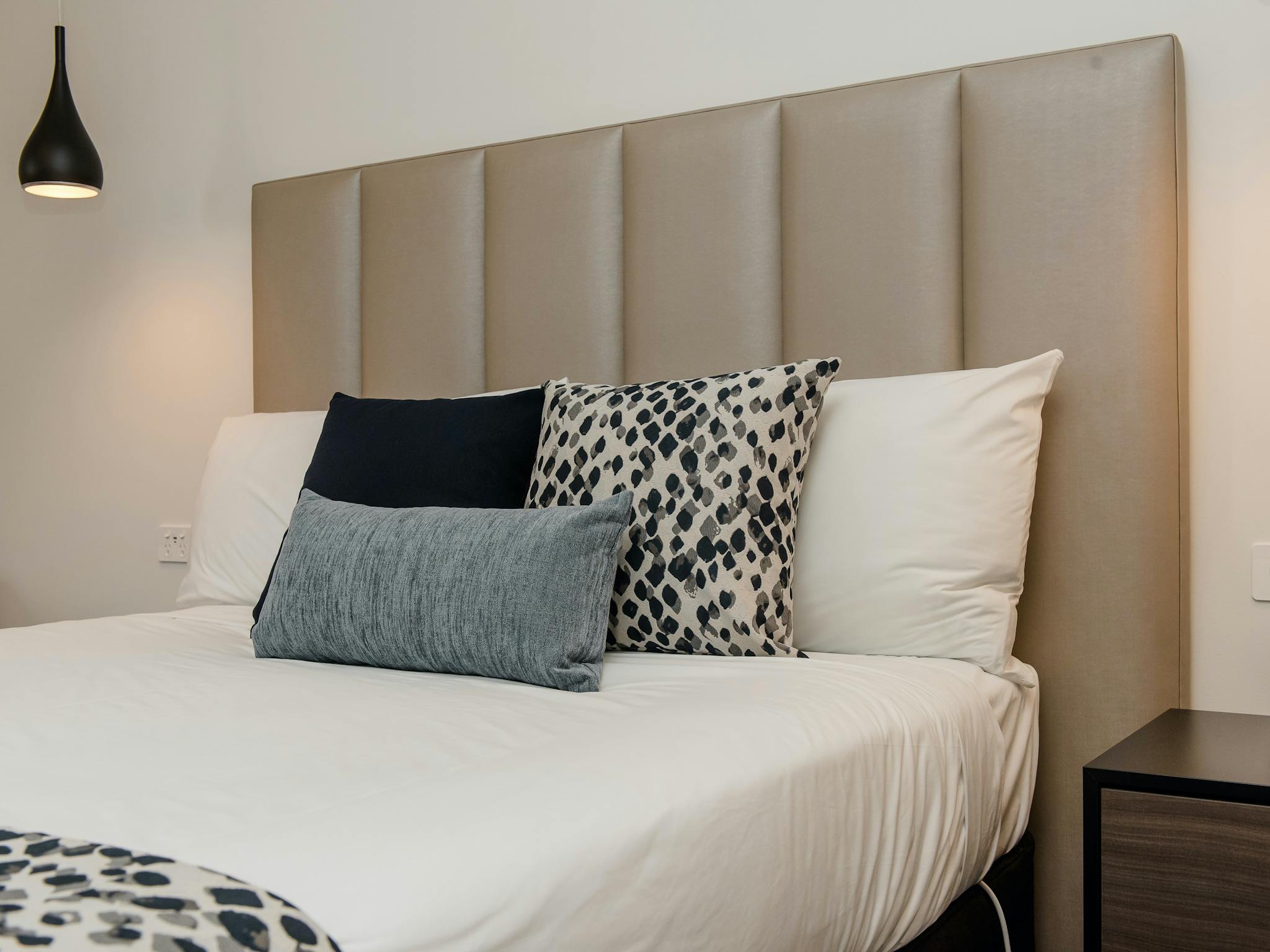 Detail shot of luxurious, comfortable bed with cushions and lighting at The Gateway
