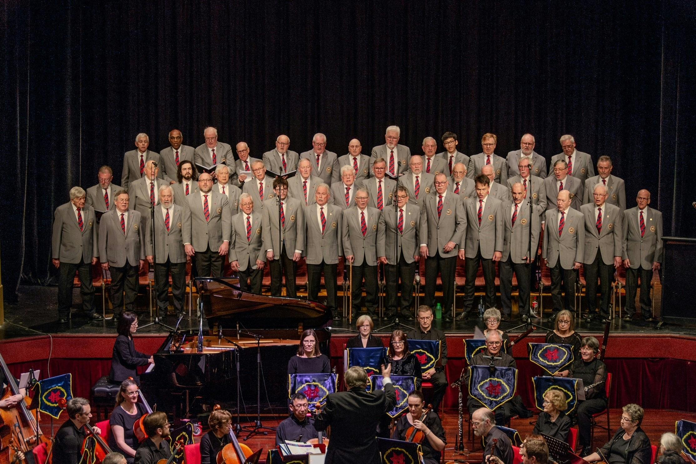 The Choir in formal uniform in concert with symphony orchestra accompanying