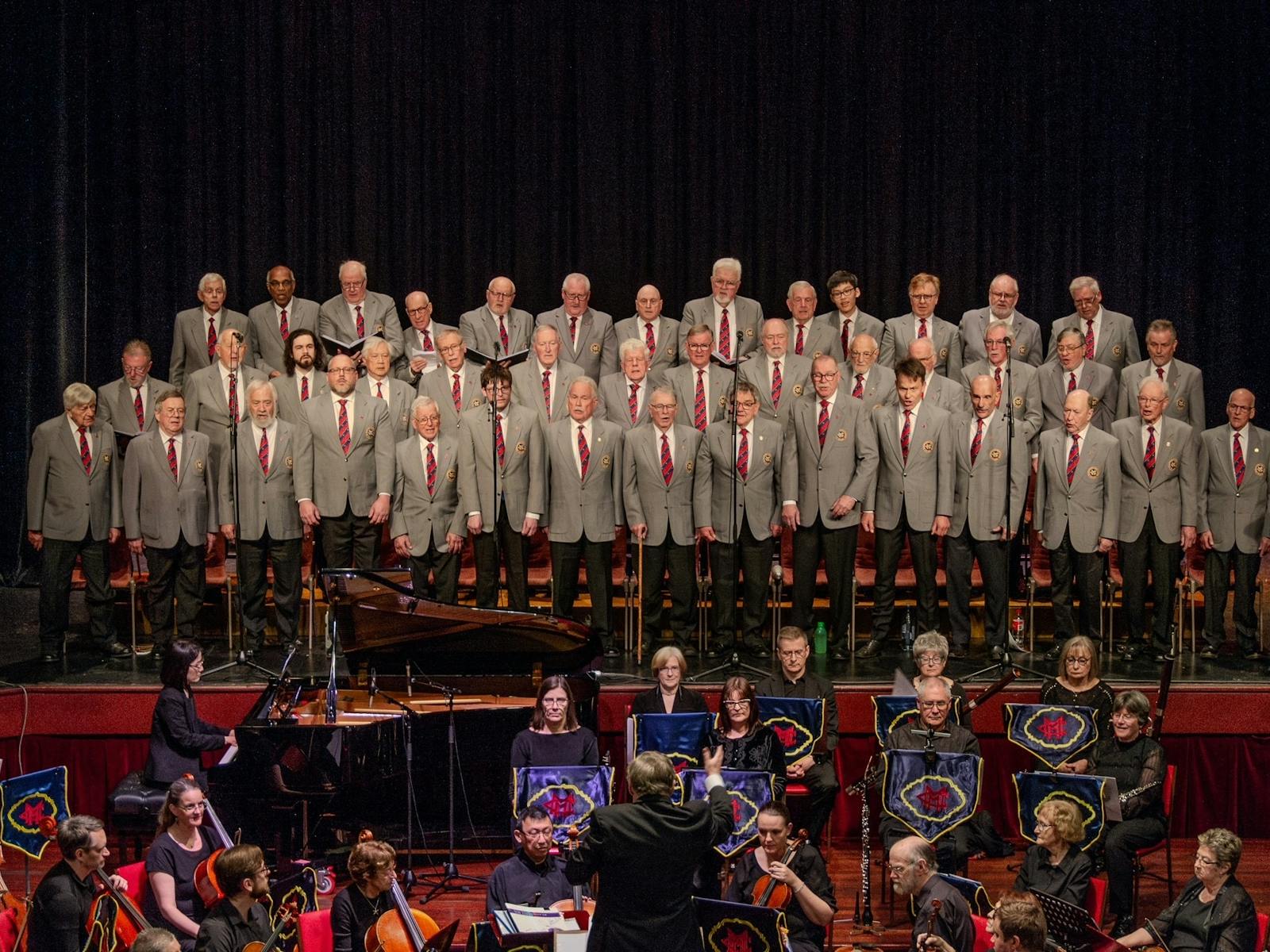 The Choir in formal uniform in concert with symphony orchestra accompanying