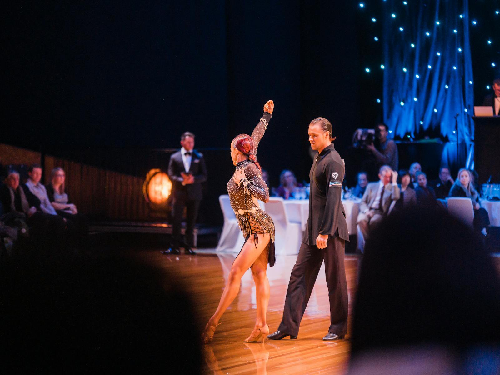 Two dancers on the floor being watched by audience at tables