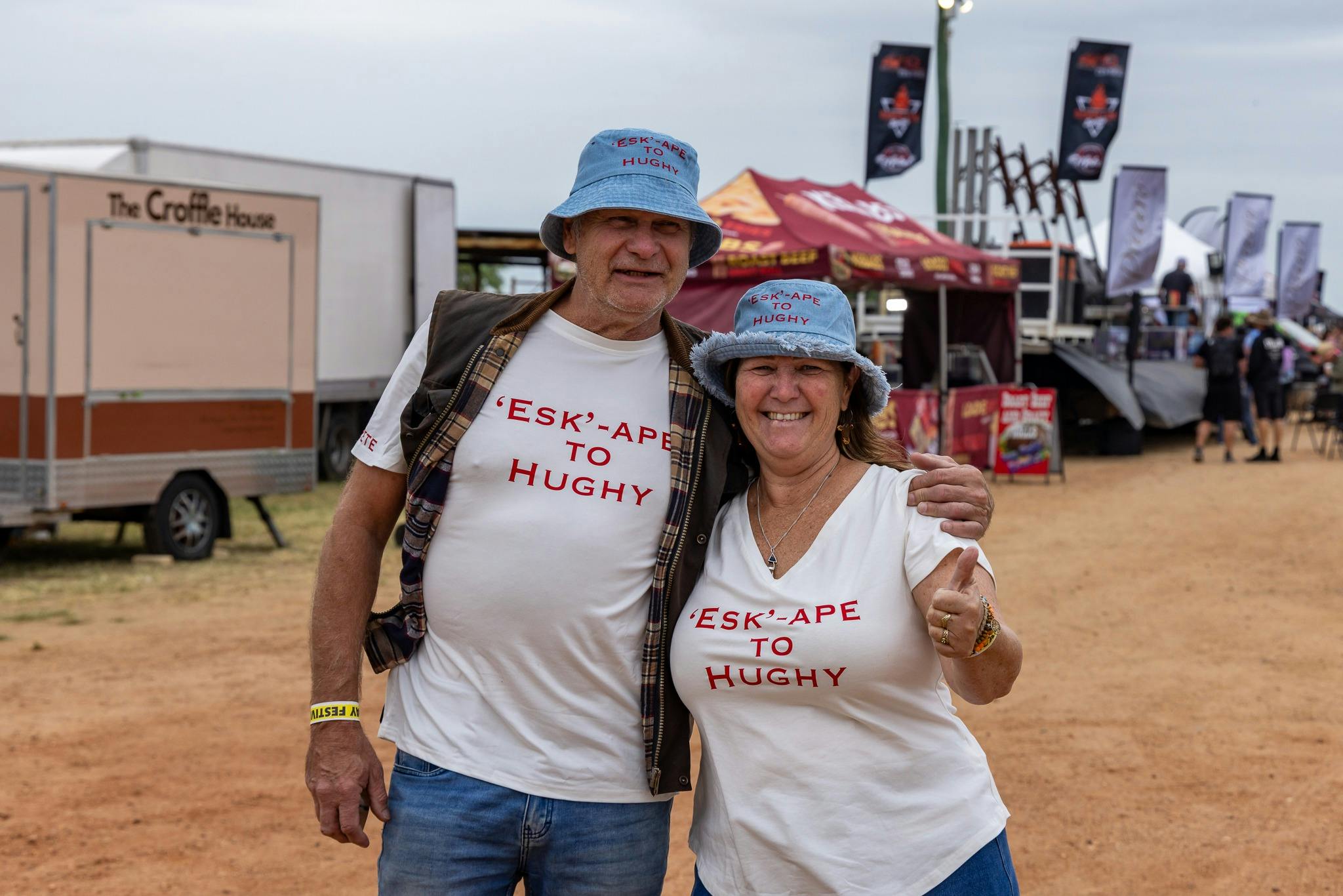 A lady and a man with t-shirts on that say esk-ape to Hughy