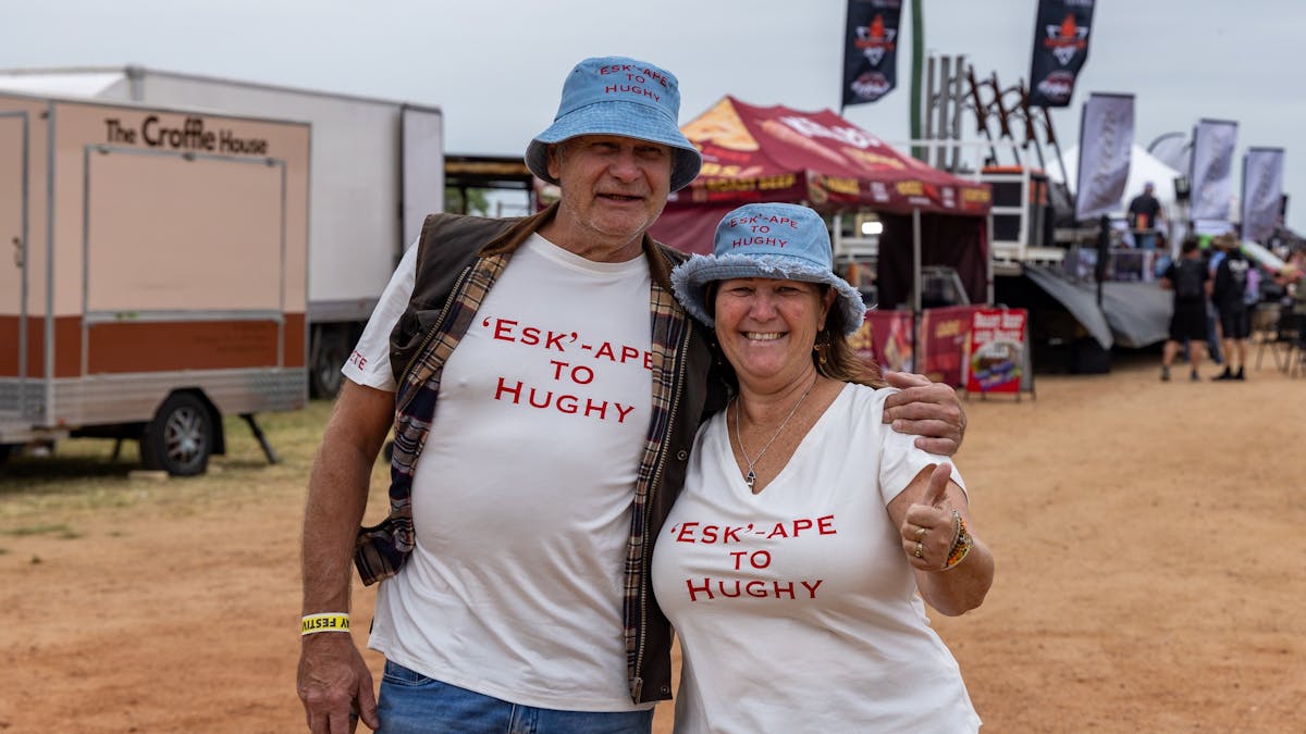 A lady and a man with t-shirts on that say esk-ape to Hughy
