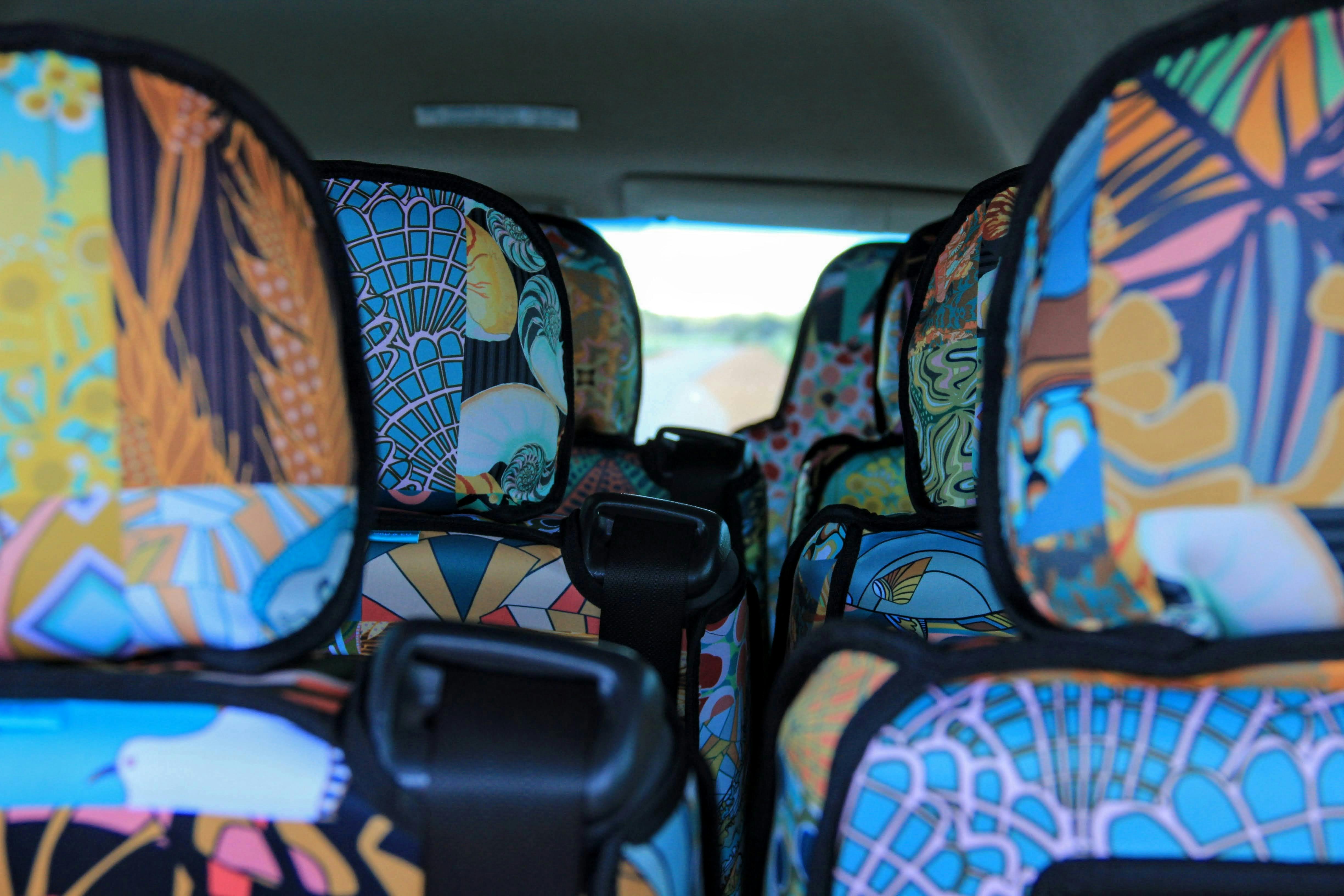 Attractive seat covers featuring local art on tour buses