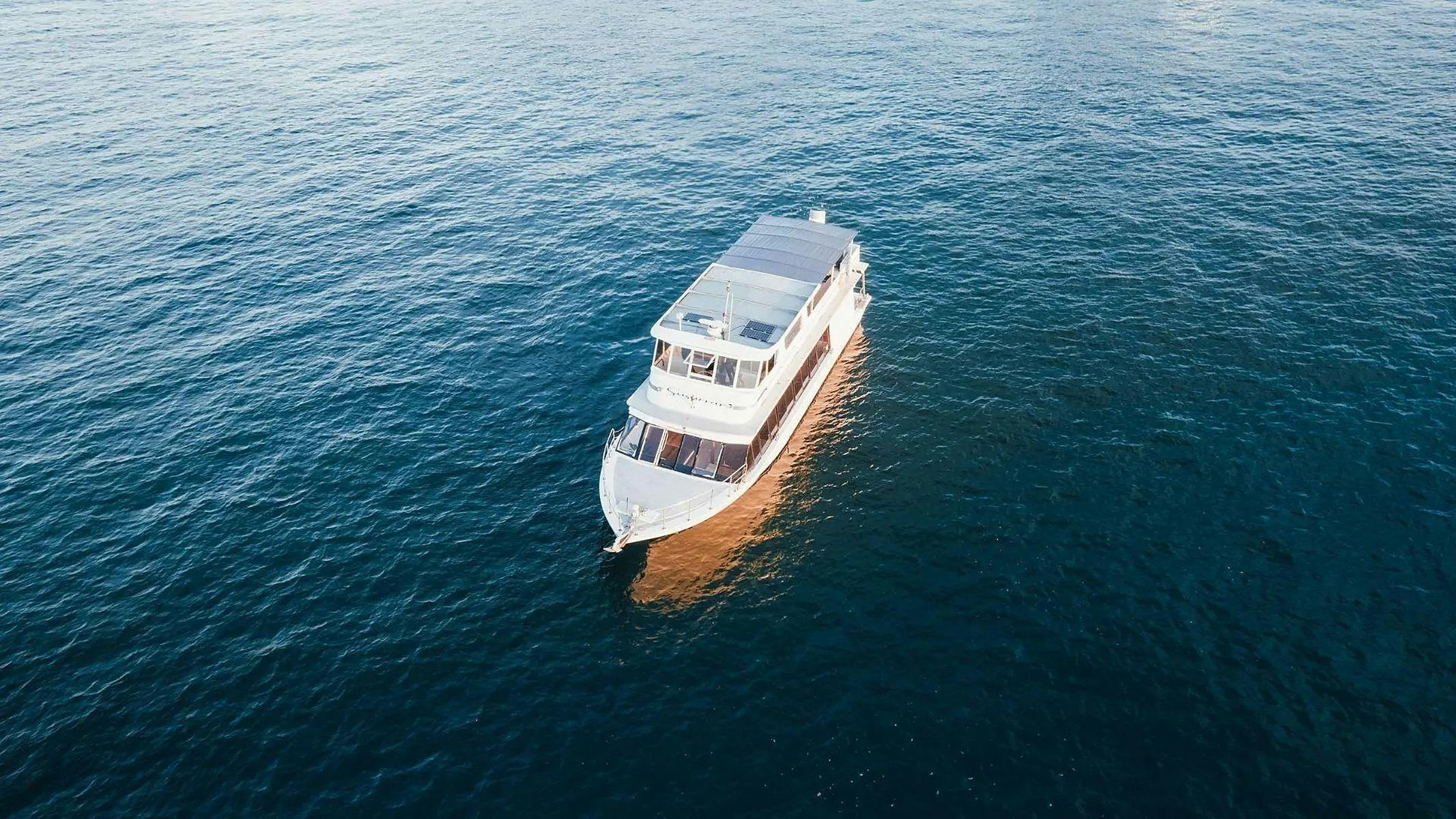 Drone shot looking down on Zahara surrounded by deep blue harbour water