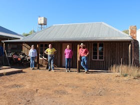 Sally, David, Keziah and John Henery, Generation 5 & 6, in front of original Alpana cottage.