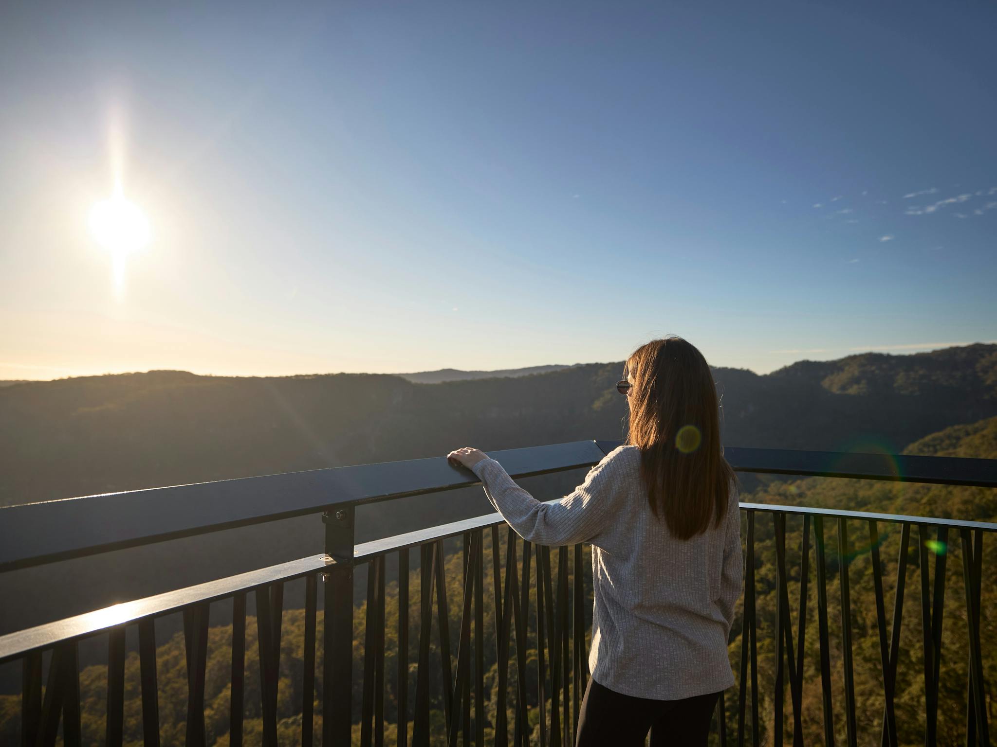 Woman overlooking the Lamington National Park with Edge Park access at Happitat Woman overlooking the Lamington National Park with Edge Park access at Happitat