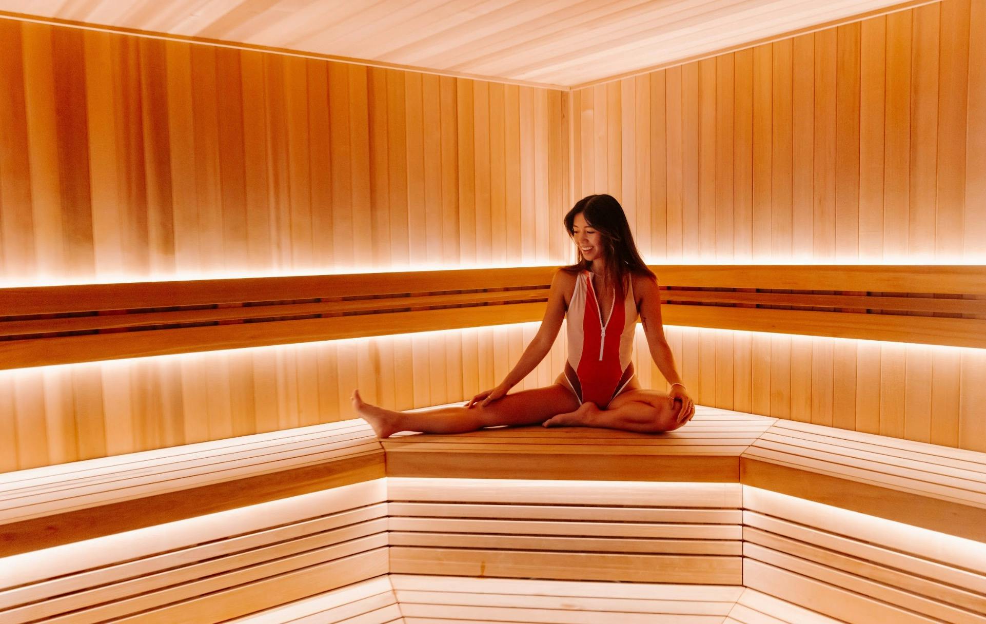 woman stretching in sauna