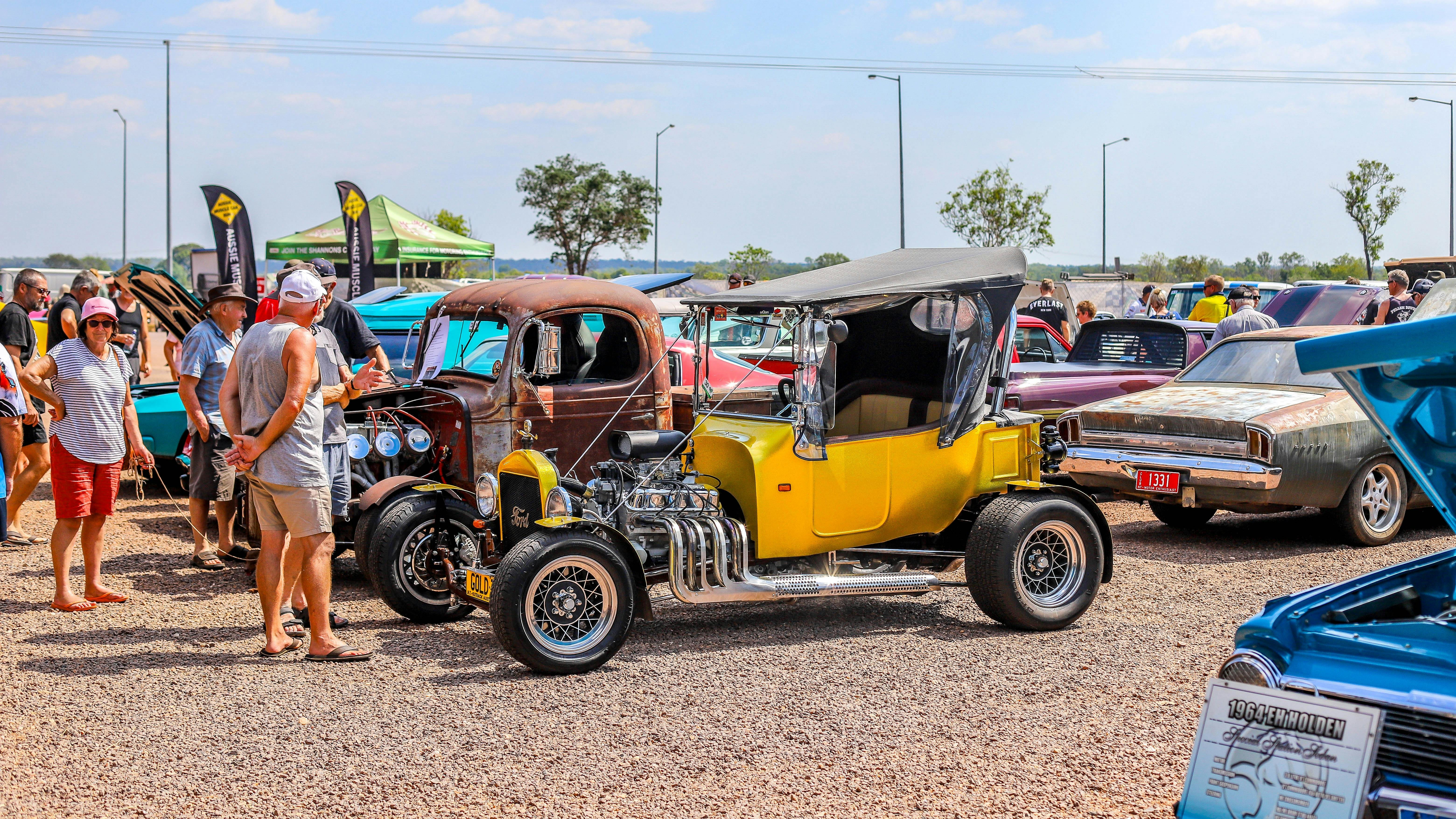 People admiring all the classic cars in the line up