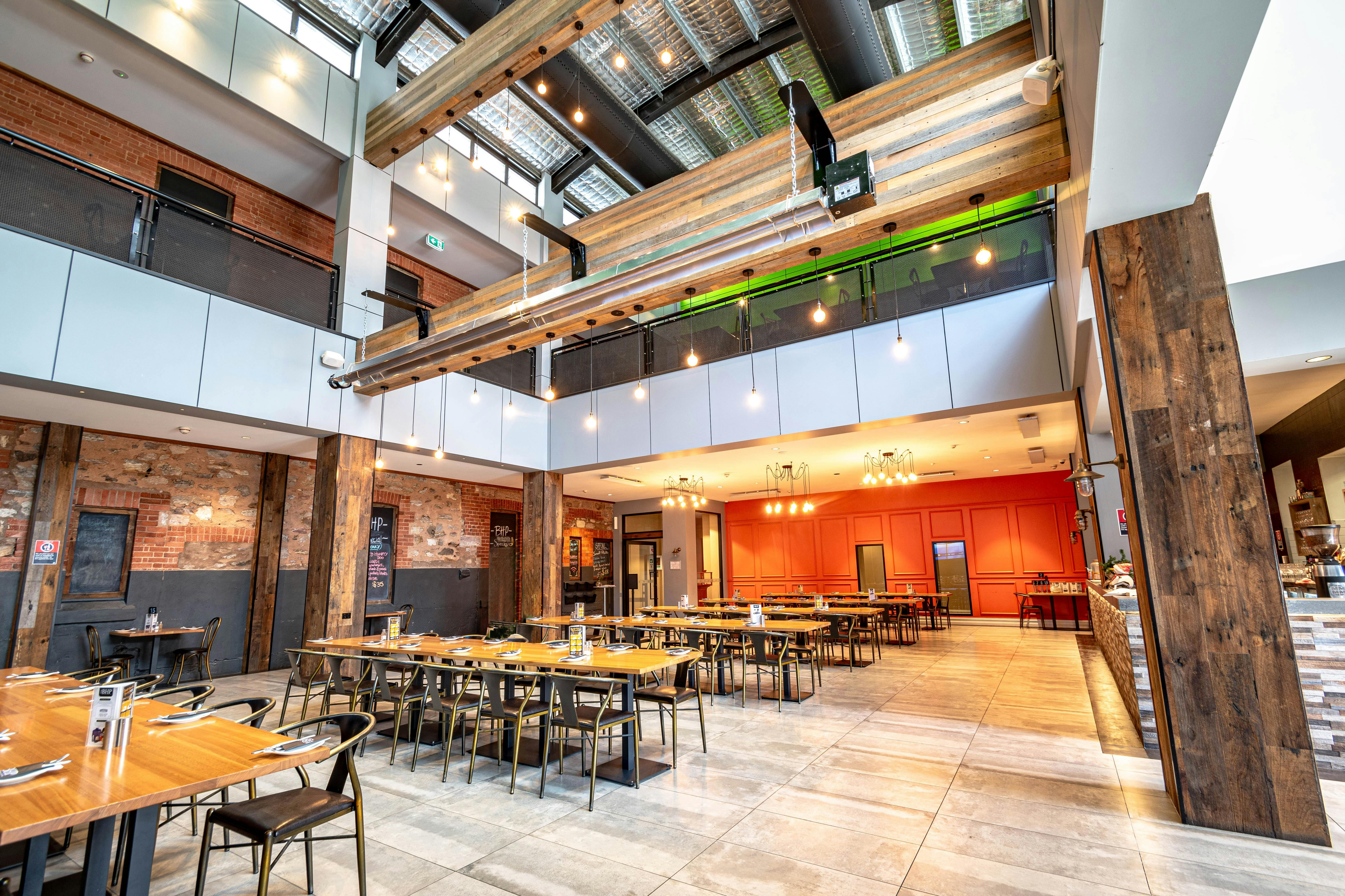 Interior image of The BHP Bistro, showing the dining area and the atrium above to the first floor.