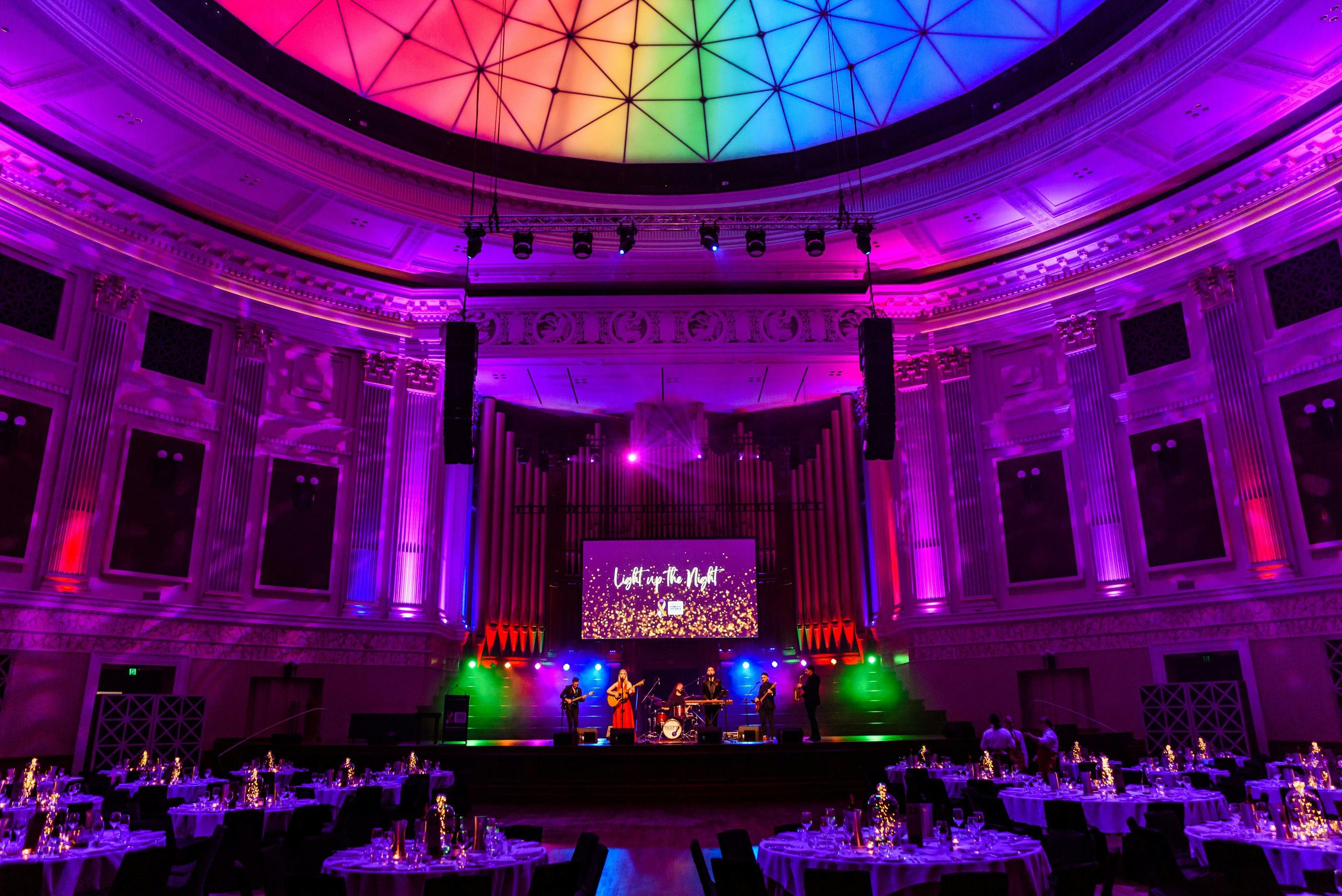 Vibrant scene in the main auditorium of Brisbane City Hall during the Light Up the Night Gala