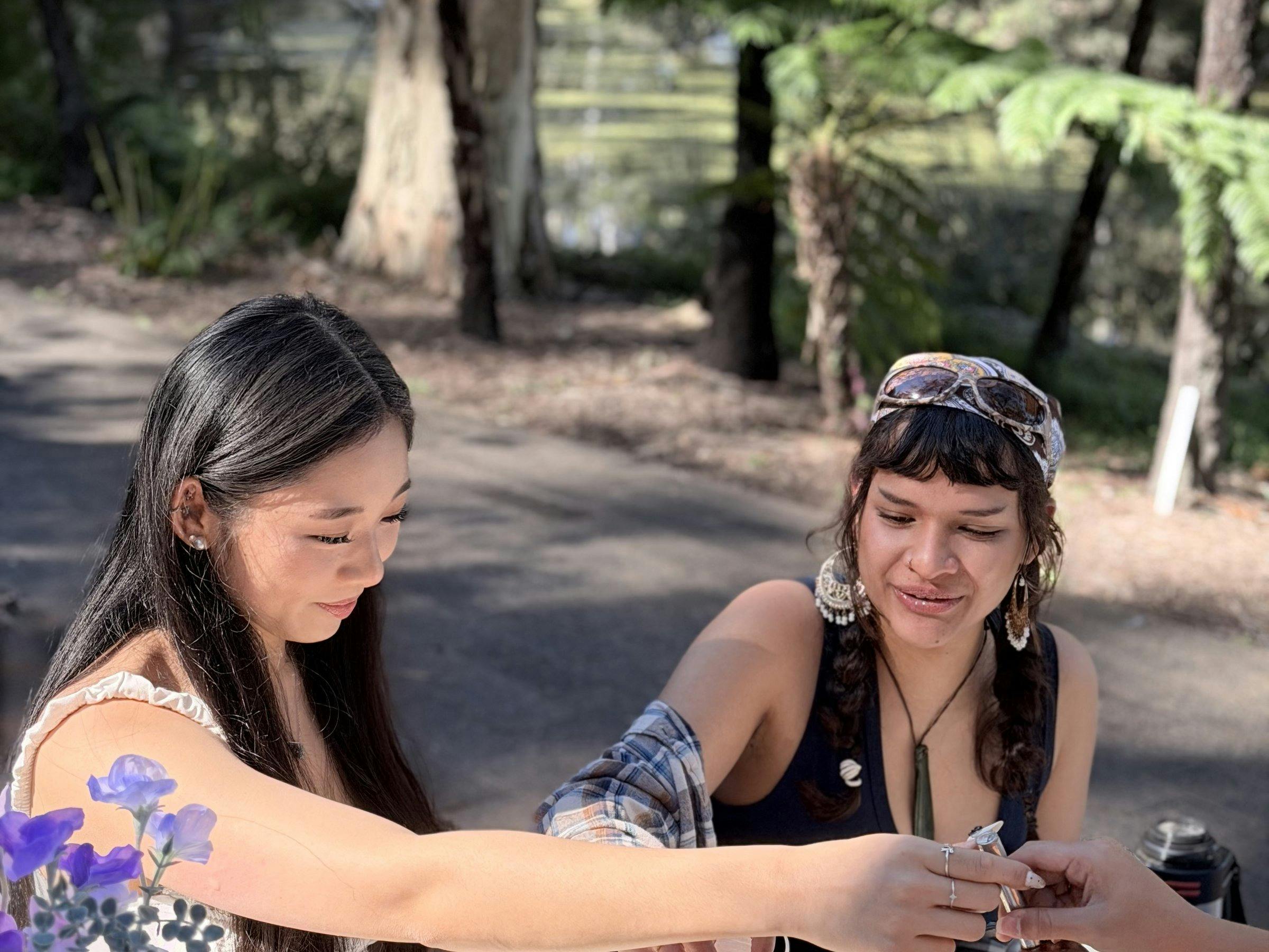 Guest hand-painting a ceramic cup at a NOA Matcha workshop