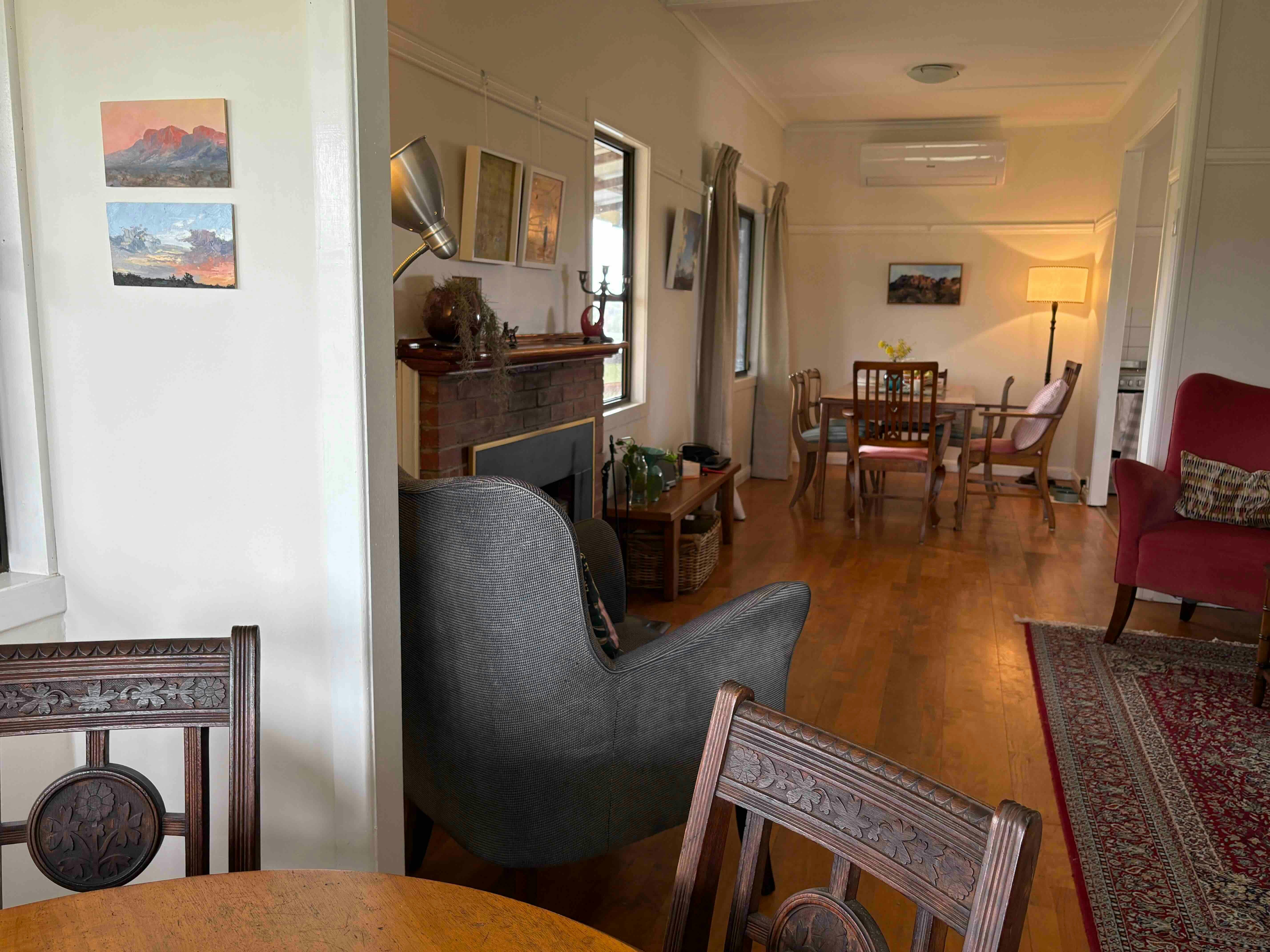 Living and dining room of cottage with rustic antique furniture