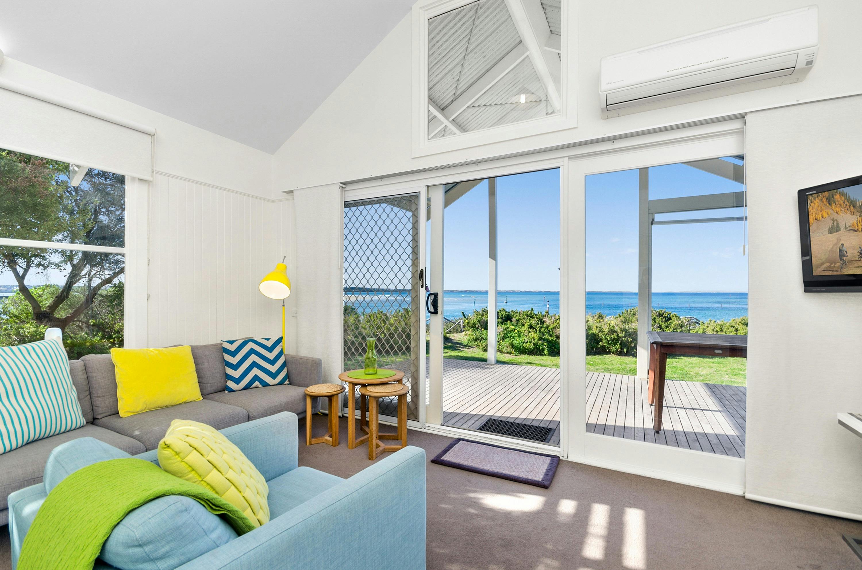 View of a lungeroom with waterfront views in our Beach Houses