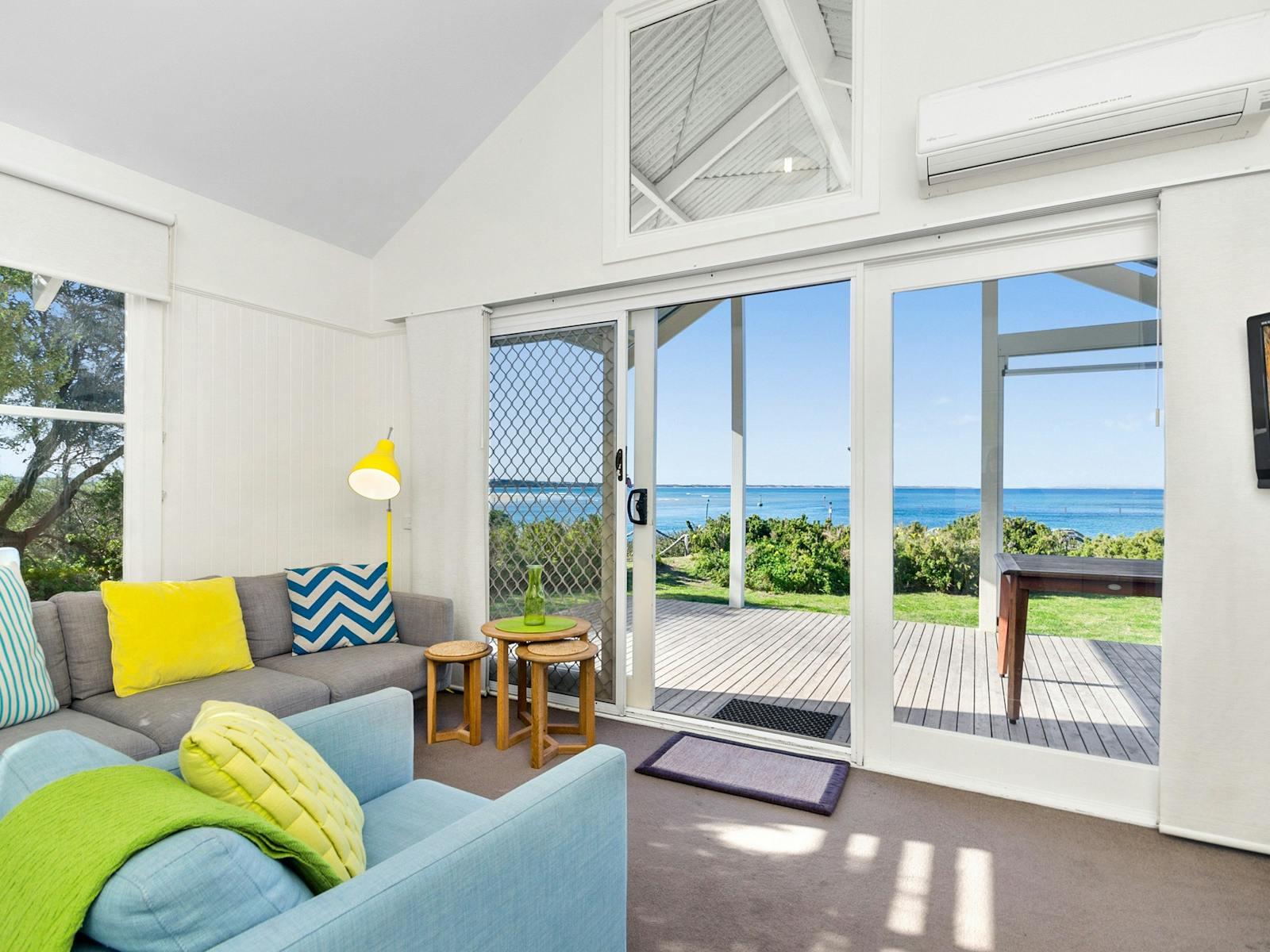 View of a lungeroom with waterfront views in our Beach Houses