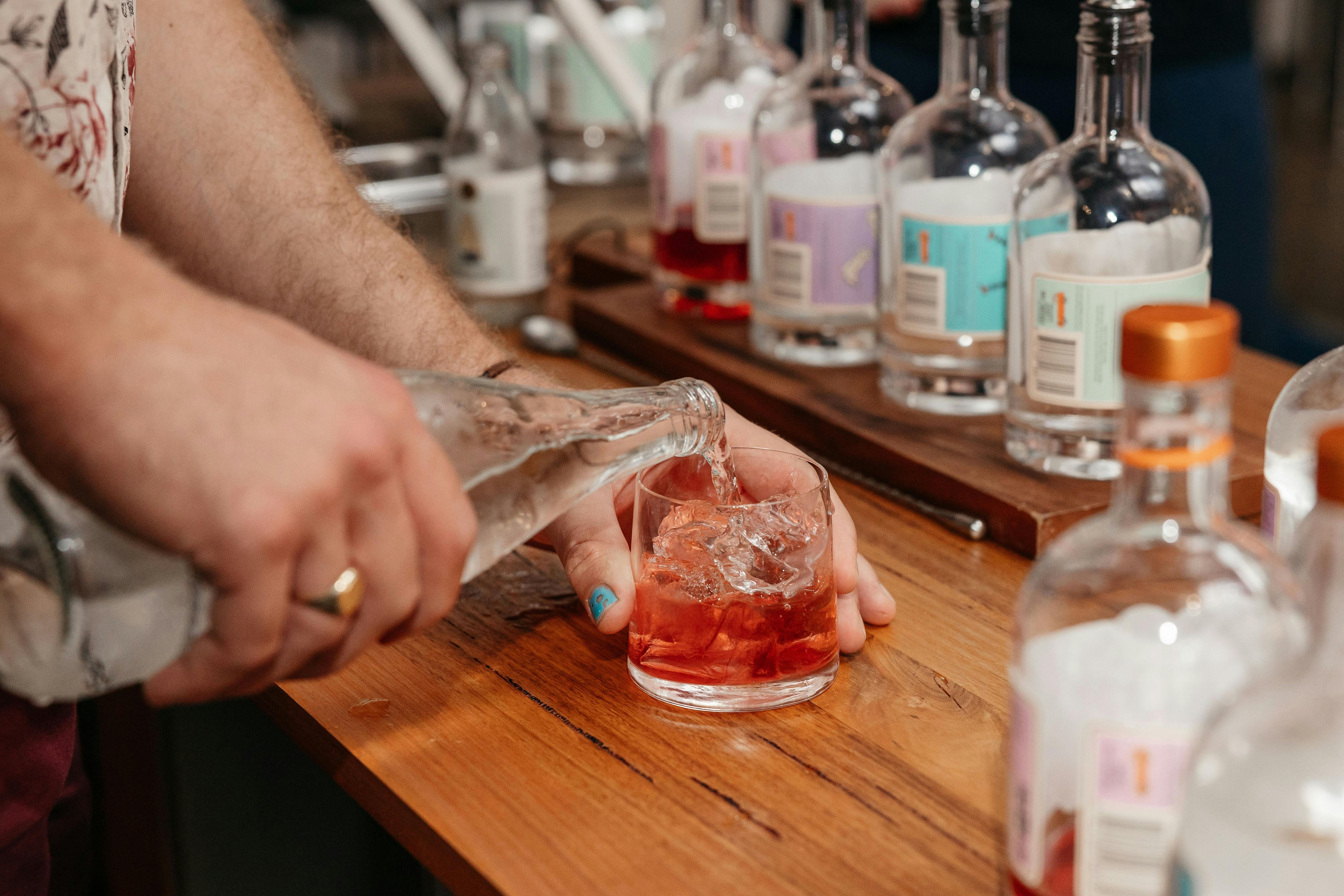 pouring pink gin and tonic